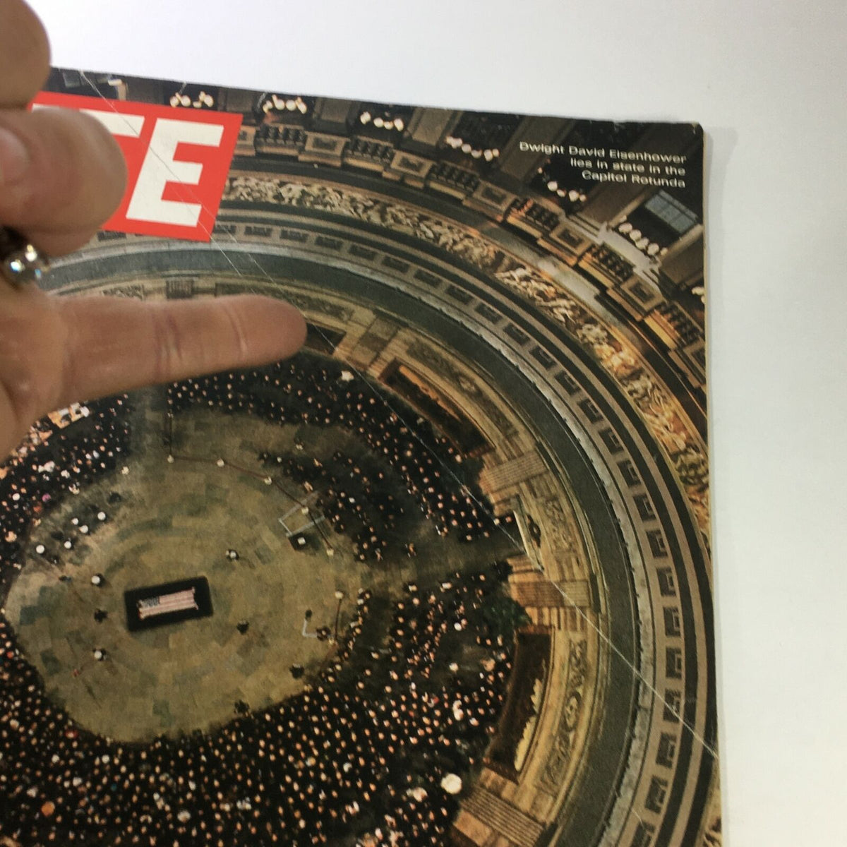 Close-up of the Vintage Life Magazine cover from April 11, 1969, highlighting the funeral of Dwight David Eisenhower with an aerial view and a glimpse of the magazine's corner.