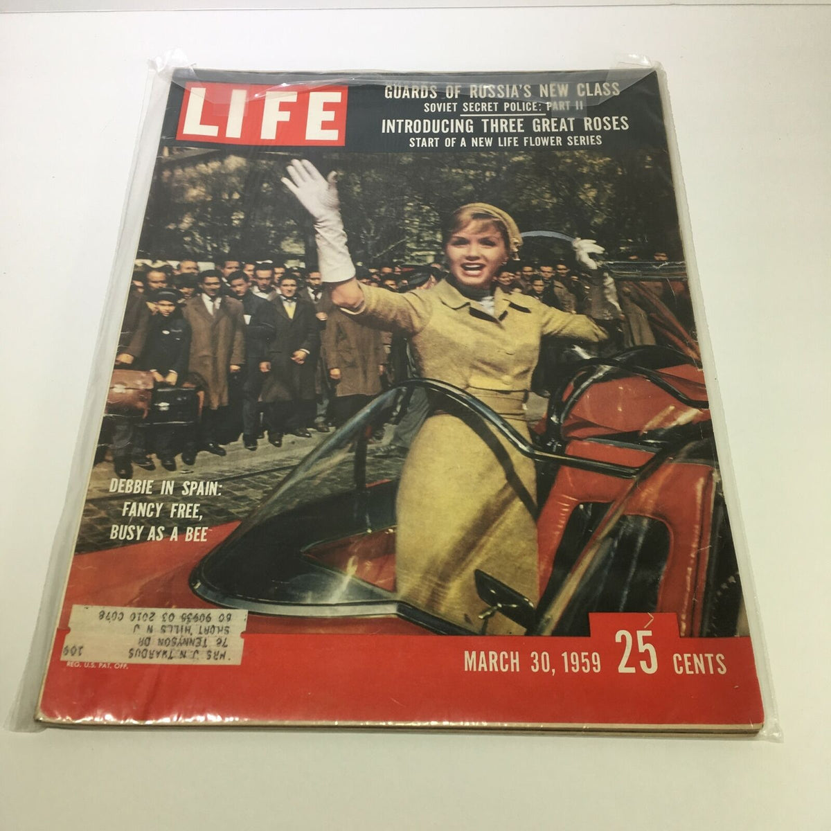 Cover of Life Magazine dated March 30, 1959 featuring Debbie Reynolds in Spain, with the headline 'Fancy Free as a Bee'. The image shows Reynolds smiling and waving, dressed in a stylish outfit, surrounded by a crowd.