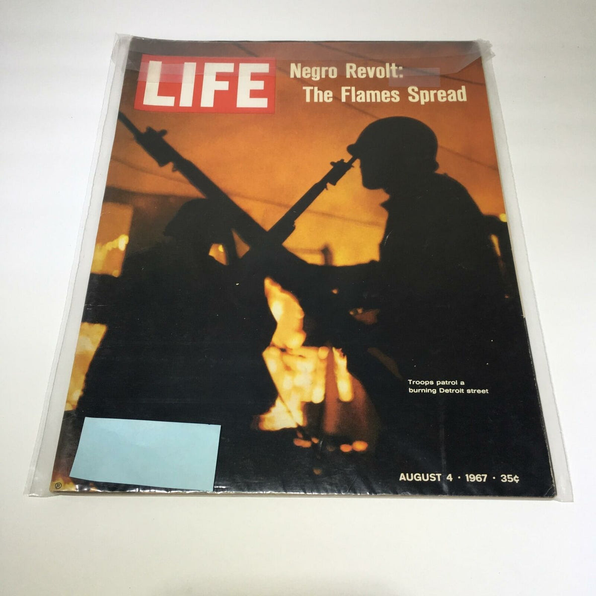 Vintage Life Magazine cover from August 4, 1967, featuring the title 'Negro Revolt: The Flames Spread' with an image of troops patrolling a burning Detroit street, reflecting historical events.