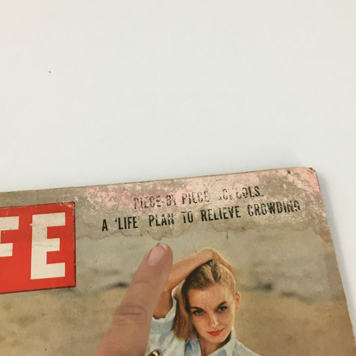 Close-up of the VTG Life Magazine February 1 1954 cover showing the title 'A Life Plan To Relieve Crowding' and a woman's hand pointing.