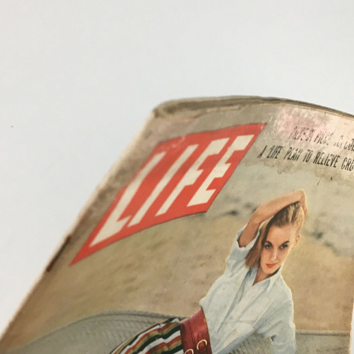 Angle view of the VTG Life Magazine February 1 1954, showcasing the title and imagery of a woman, emphasizing the vintage aesthetic.