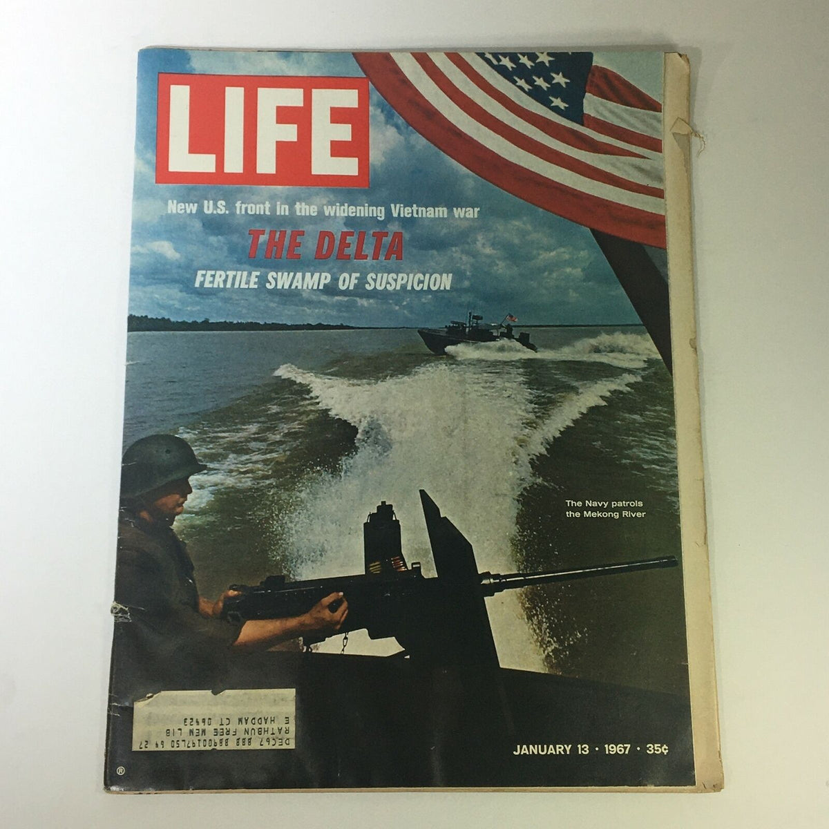 Cover of VTG Life Magazine January 13 1967 featuring The Delta Fertile Swamp, showcasing a soldier in a boat patroling the Mekong River with an American flag in the background.