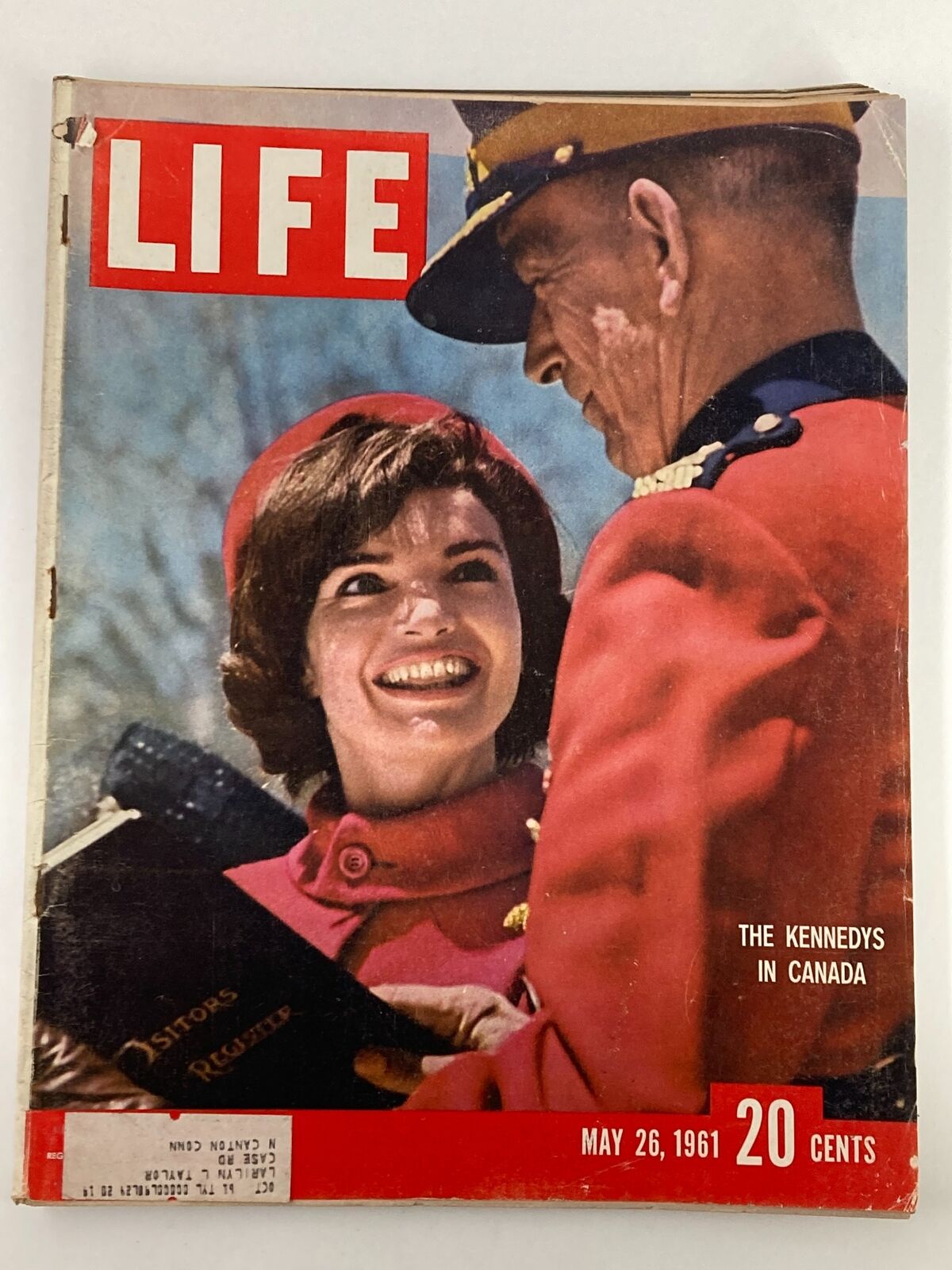 Cover of VTG Life Magazine dated May 26, 1961, featuring Jacqueline Kennedy smiling with a Canadian Mountie during the Kennedys' visit to Canada. The magazine showcases vintage charm with a nostalgic address label and minor wear, perfect for collectors.