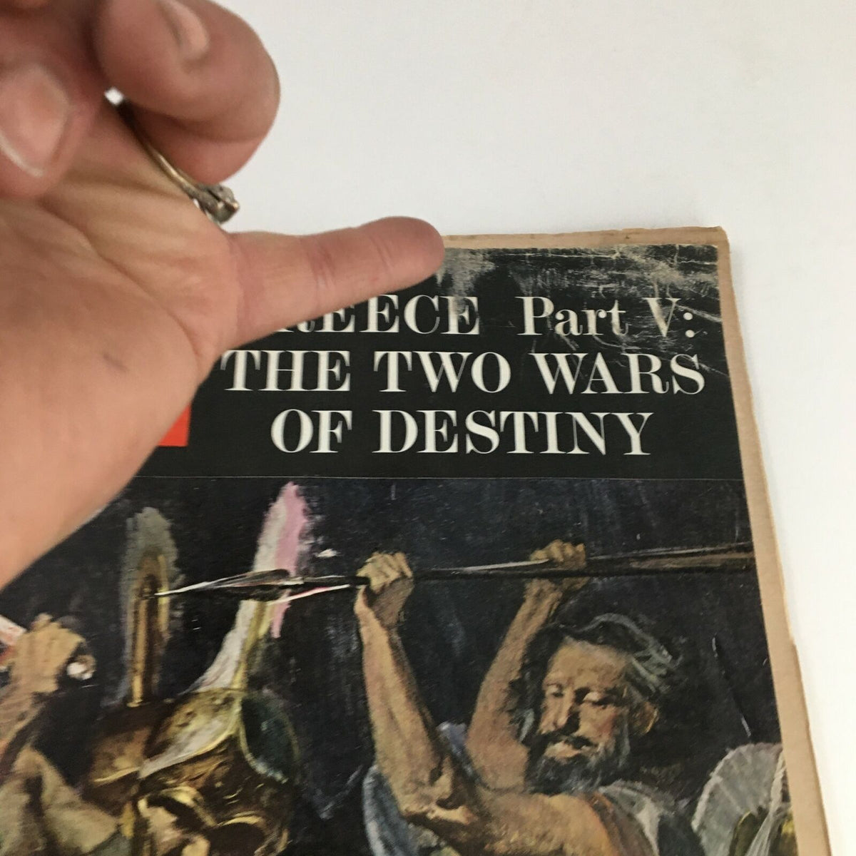 Close-up view of the Life Magazine April 5 1963 Greece Part V The Two Wars of Destiny cover, showing detailed artwork of Spartan warriors, with visible wear indicating its vintage condition.