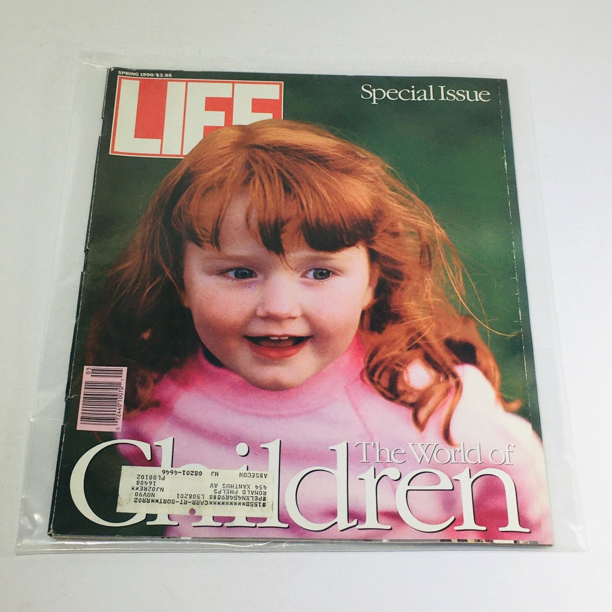 VTG Life Magazine Spring 1990 Special Issue: The World of Children featuring a smiling young girl with red hair on the cover, encapsulated in protective plastic.