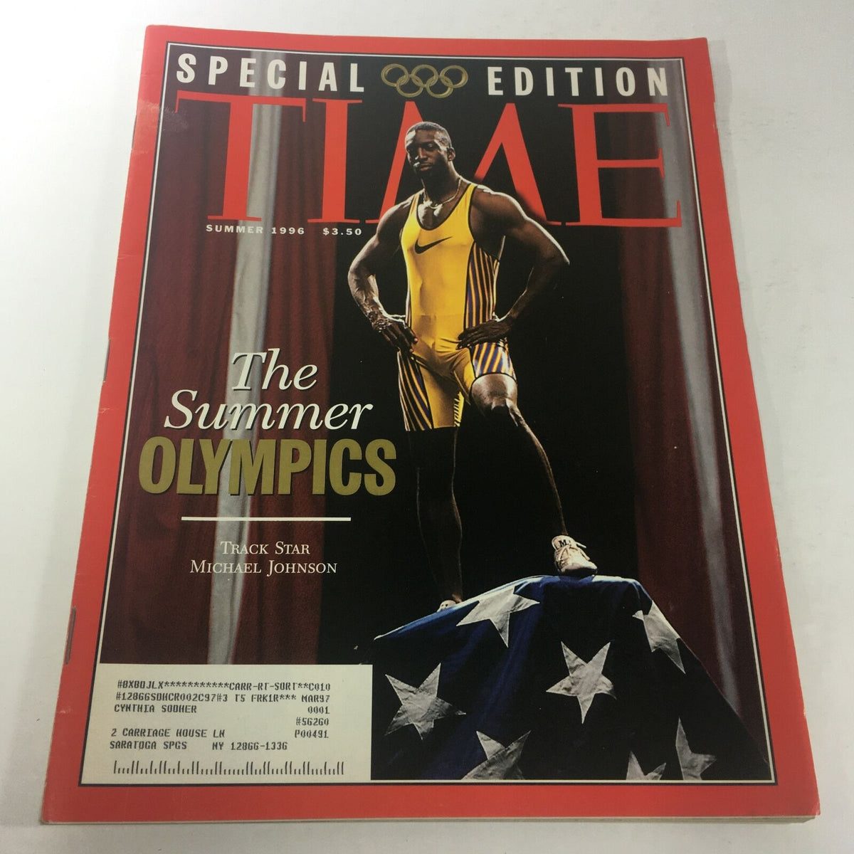 Vintage Time Magazine Summer 1996 featuring track star Michael Johnson on the cover, showcasing a special edition for the Summer Olympics with vibrant imagery and bold text.