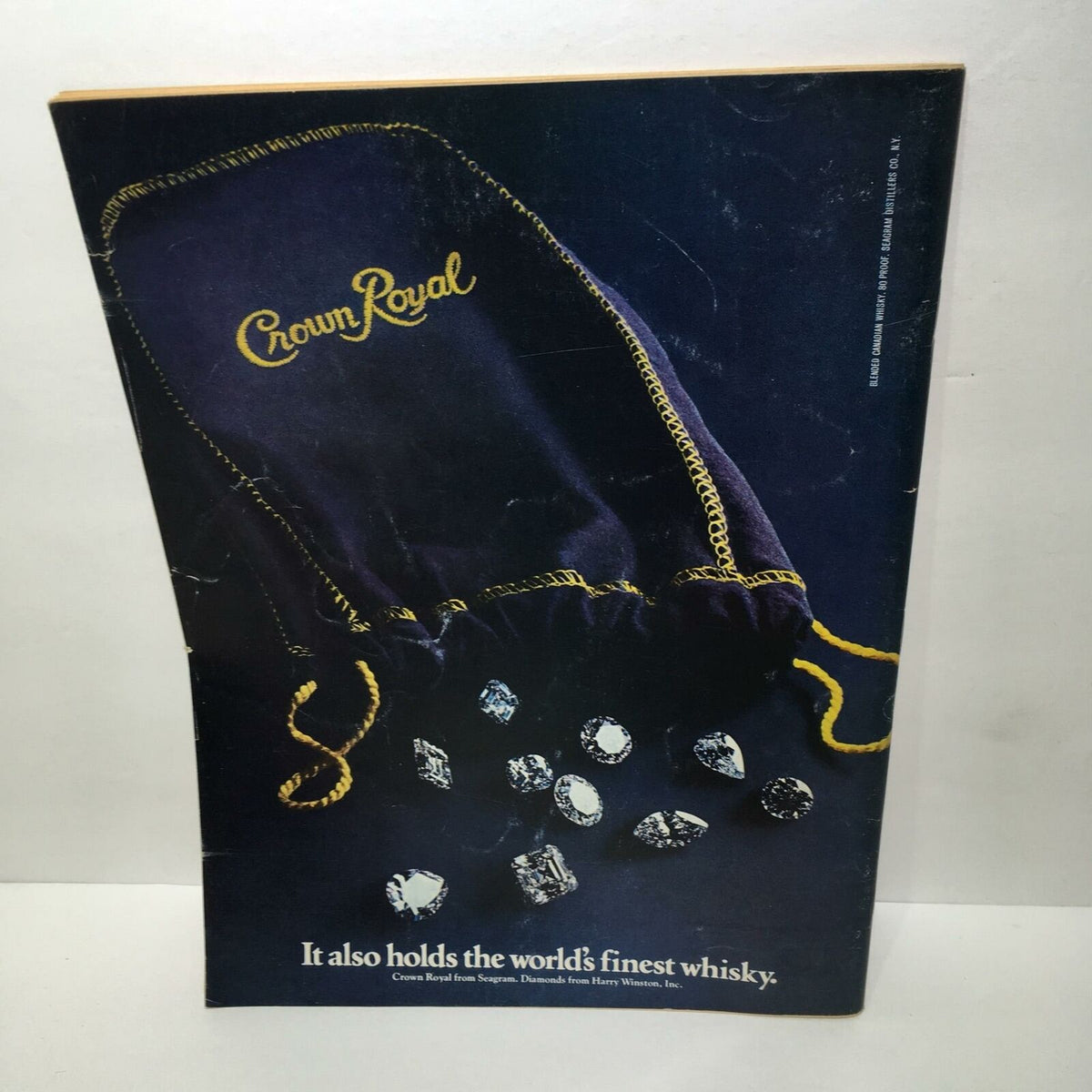 Advertisement on the back cover of Time Magazine, highlighting Crown Royal whisky with a stylish purple velvet pouch.