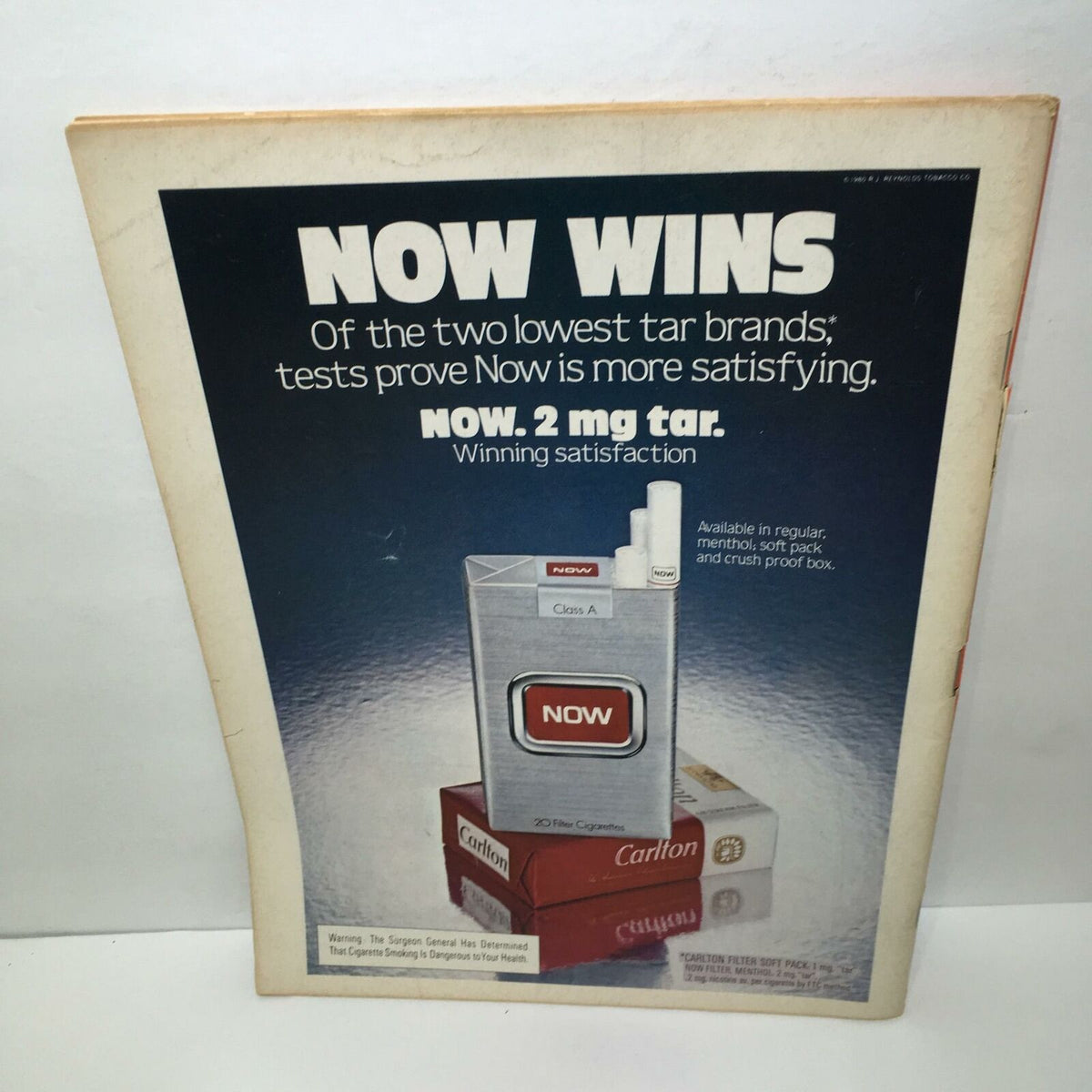 Advertisement for NOW cigarettes featured in Time Magazine February 4, 1980, highlighting their low tar content and satisfaction.