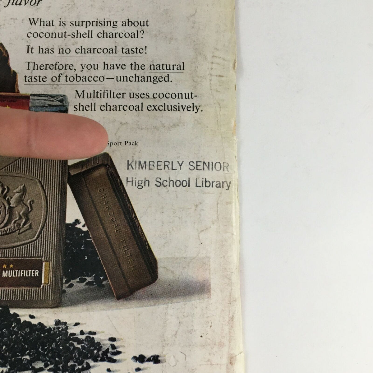 Detail of the Philip Morris Multifilter advertisement on the back page of Time Magazine from September 25, 1964, emphasizing coconut-shell charcoal for a unique cigarette flavor.