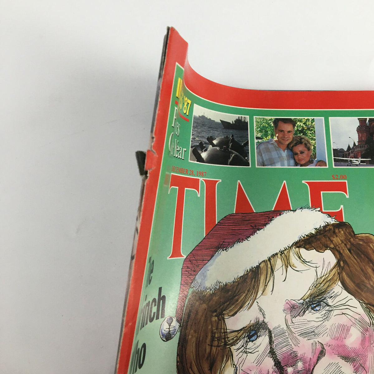 Close-up of the edge of VTG Time Magazine December 28, 1987, featuring 'The Grinch Who Stole Christmas' showing minor wear, characteristic of vintage publications.