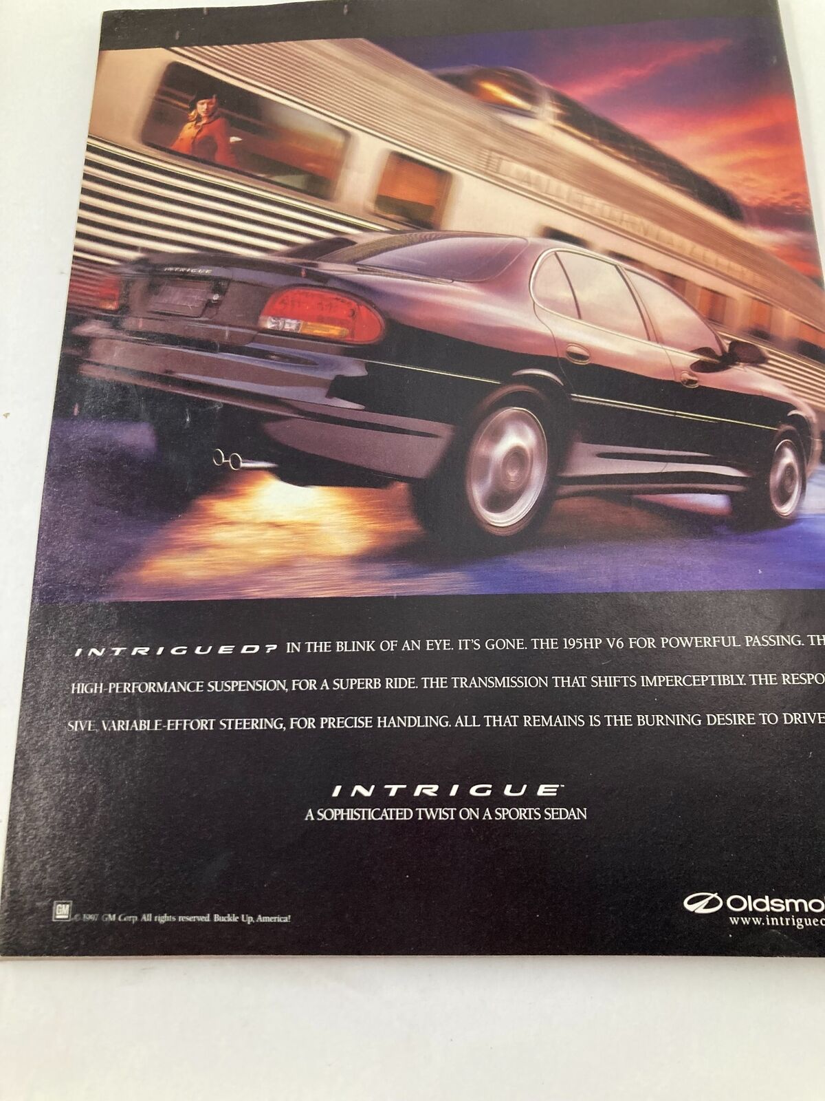 An advertisement showcasing the Oldsmobile Intrigue, highlighting its high-performance features and sleek design.