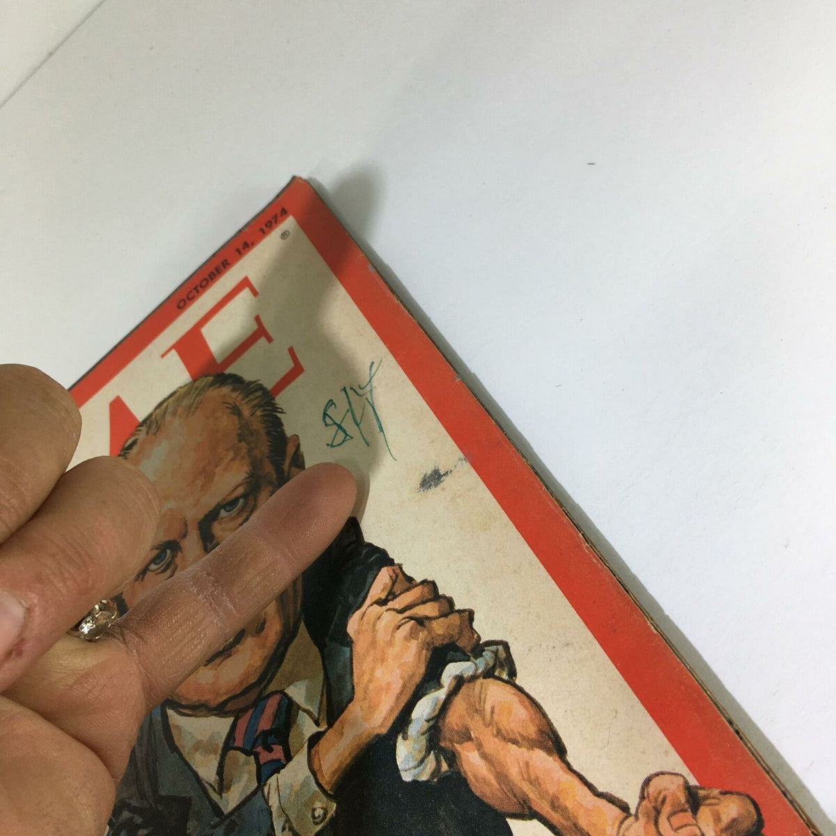Close-up of the Time Magazine Cover from October 14, 1974, displaying the title 'Trying to Fight Back' with a signature and details of wear, emphasizing its vintage charm.