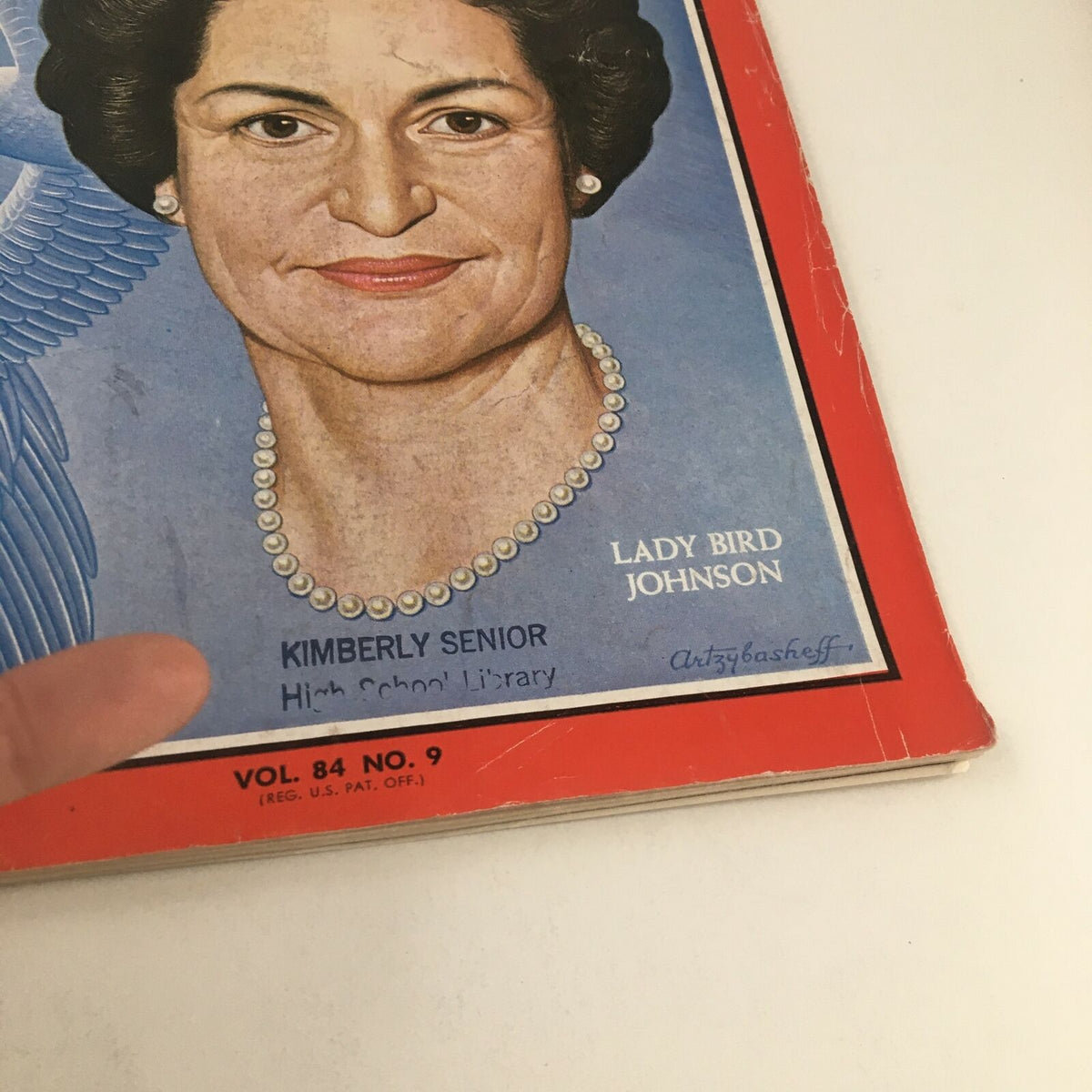 Focus on the cover of 'Time Magazine August 28 1964' featuring Lady Bird Johnson with a signature and library marking.
