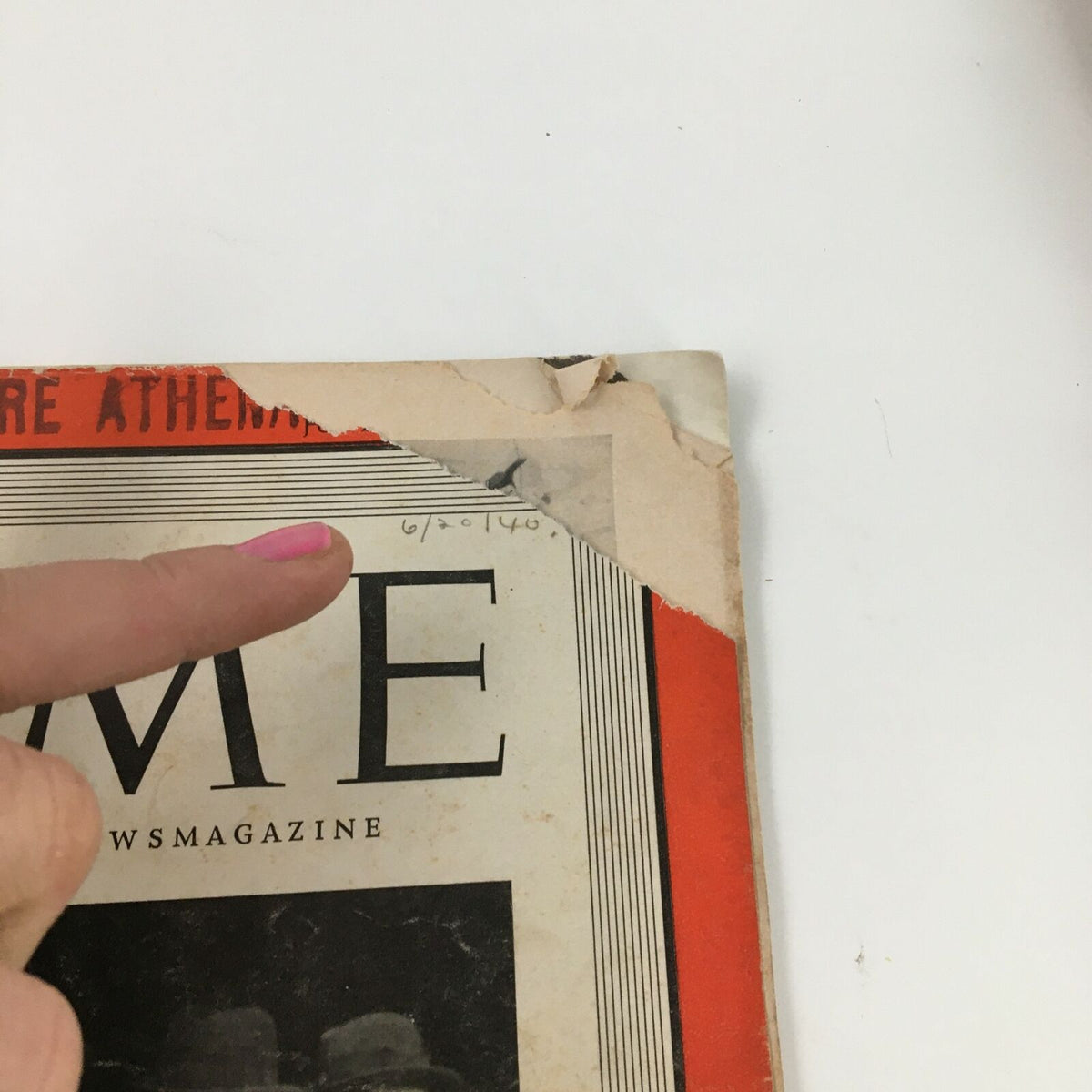 Close-up view of the damaged corner of the Time Magazine from June 17, 1940, Volume 35, Number 25, revealing details of wear and age, including handwritten date.