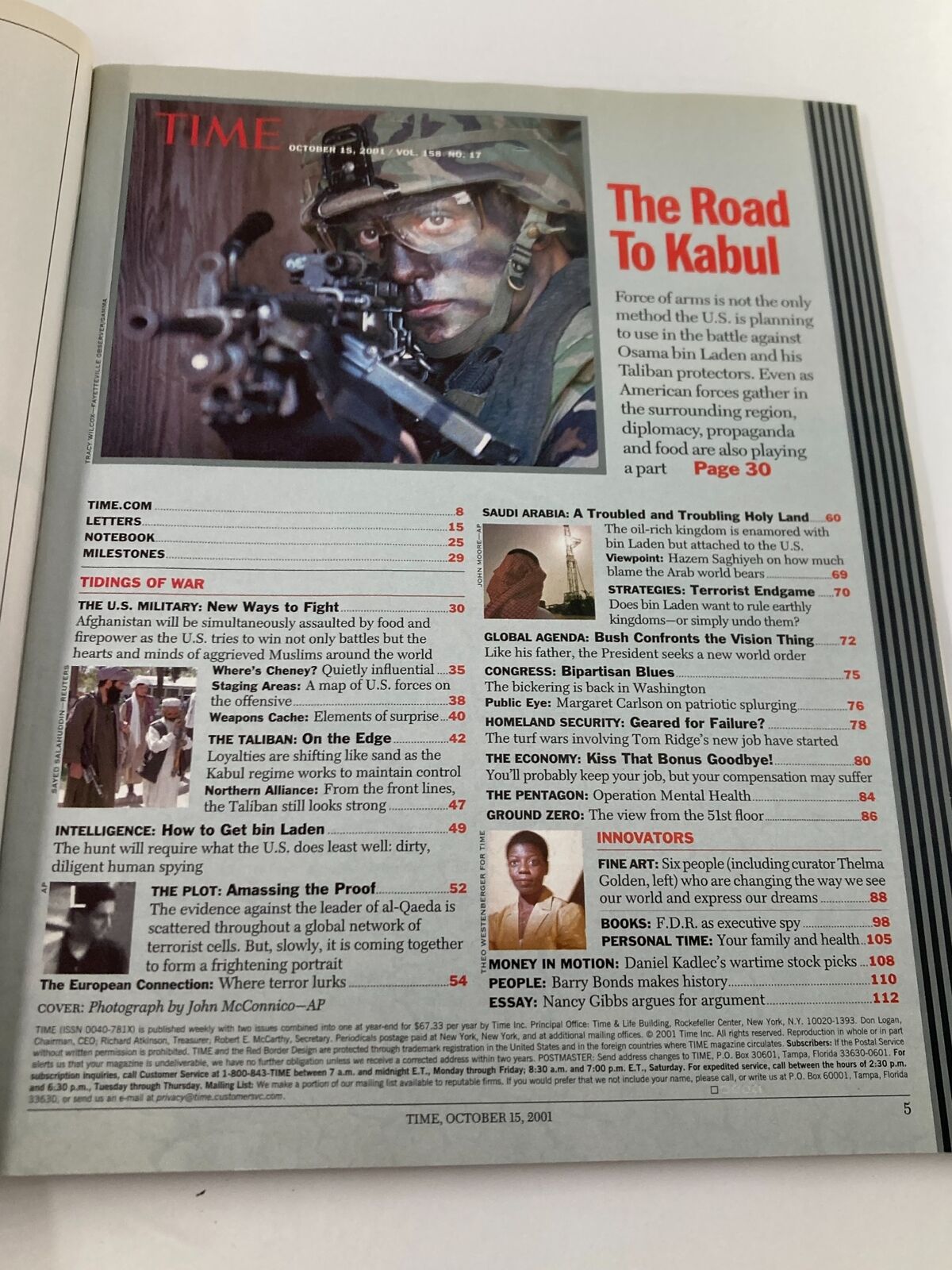 Inside page of Time Magazine from October 15, 2001, titled 'The Road to Kabul' showcasing a soldier with a rifle, emphasizing the military actions discussed in the issue.