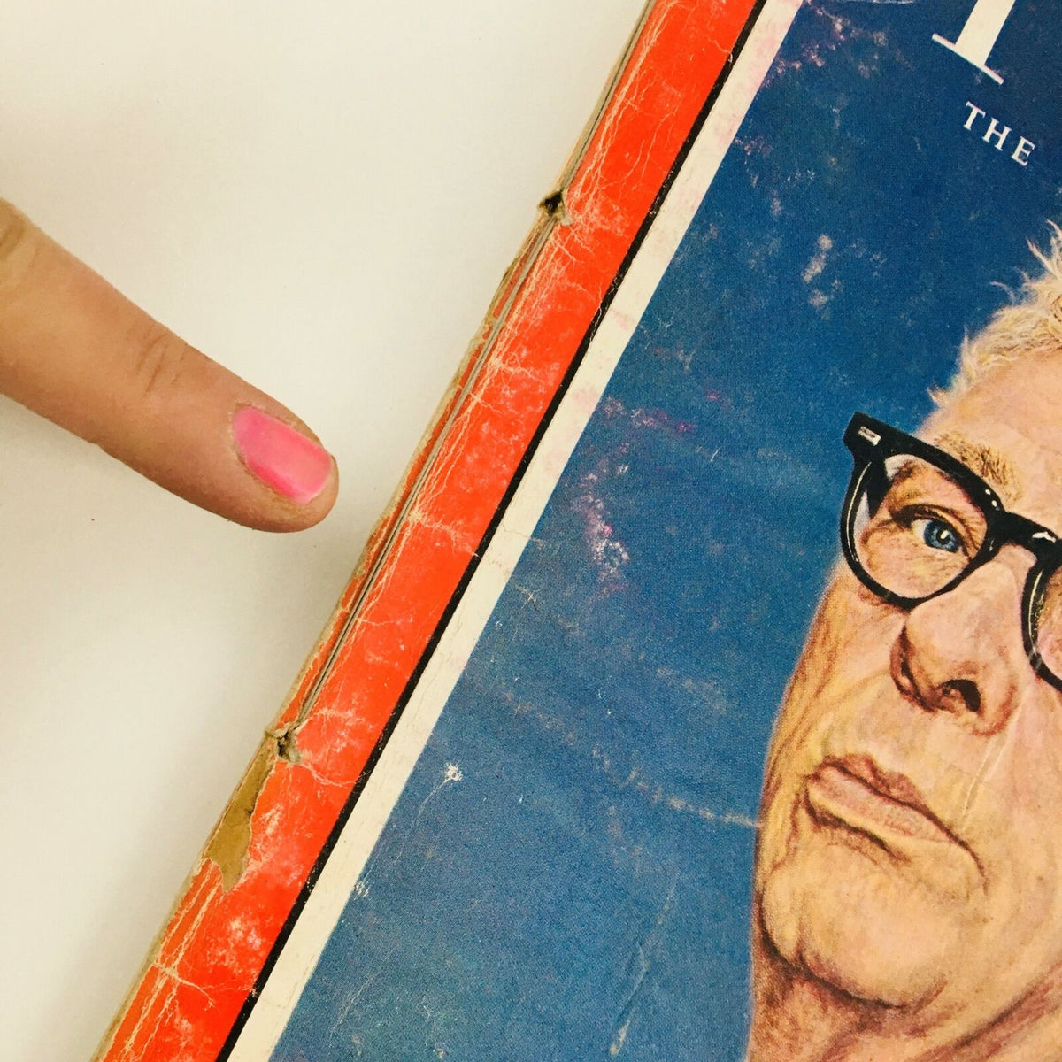 Side view of Time Magazine September 14, 1962 Vol 80 #11 featuring Senator Everett Dirksen, highlighting the spine with wear and tear from age and a finger pointing to the magazine.