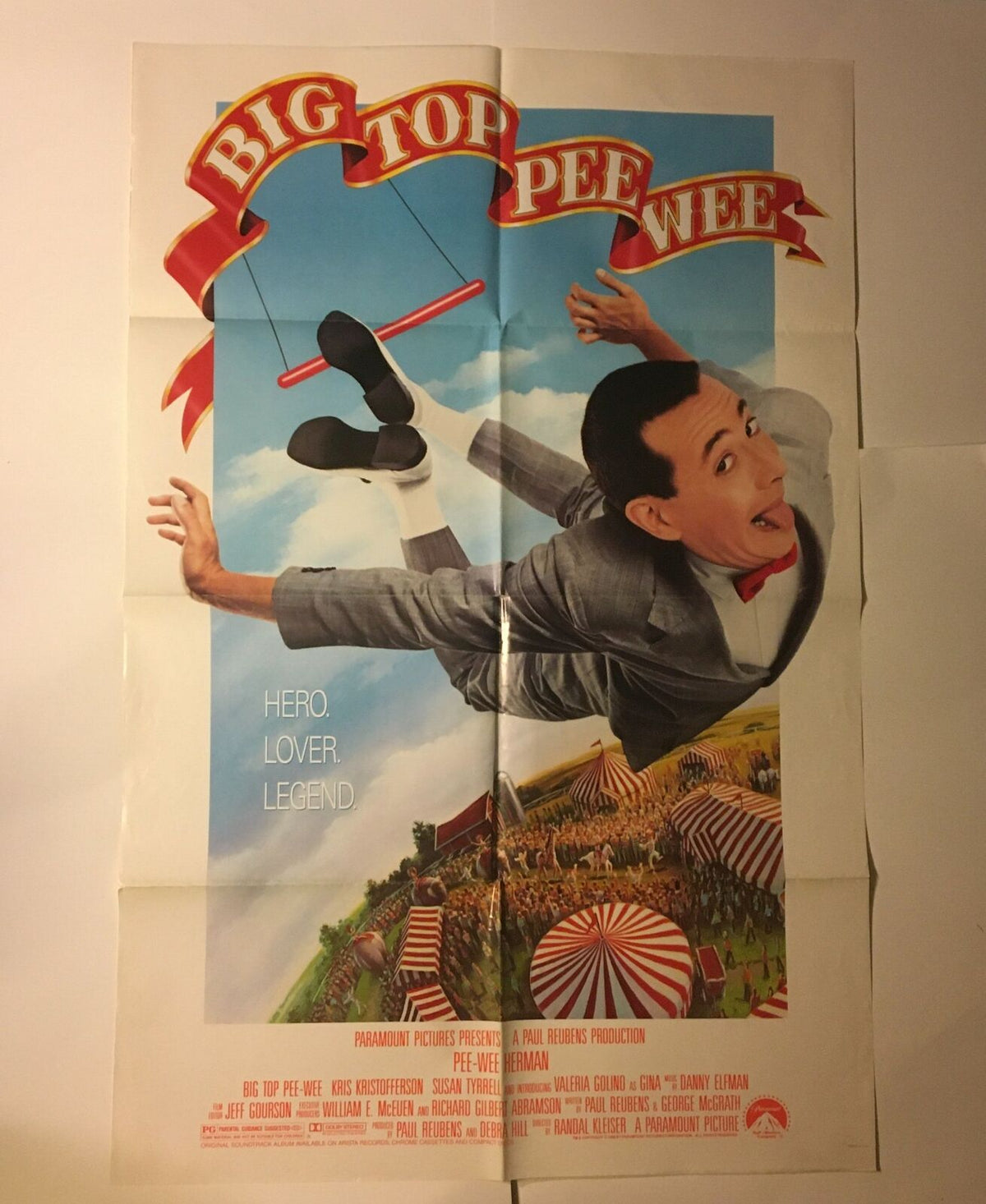 1988 Big Top Pee-Wee Herman movie poster featuring Paul Reubens in a colorful scene, showcasing whimsical circus elements with text that reads 'HERO. LOVER. LEGEND.'