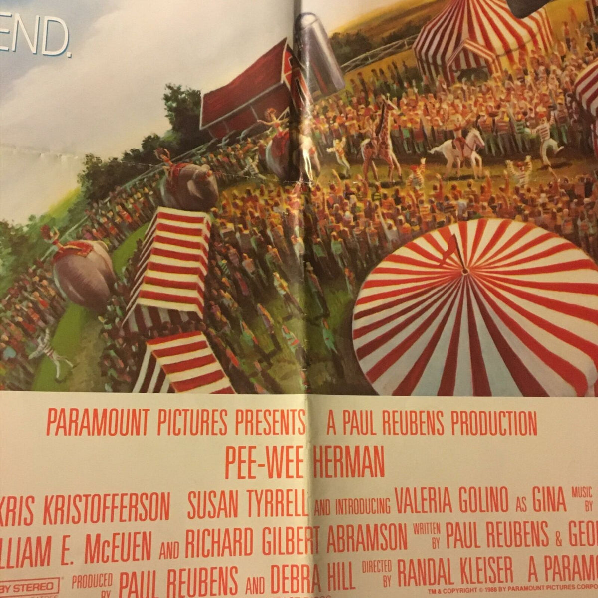Close-up view of the 1988 Big Top Pee-Wee Herman movie poster highlighting the vibrant circus crowd and striped tents, with production credits listed below.
