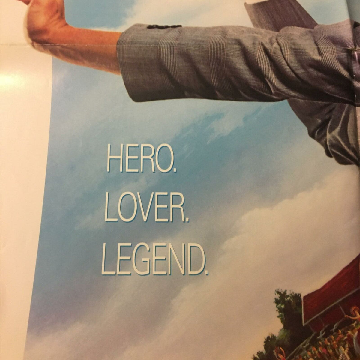 Focus on the text segment of the 1988 Big Top Pee-Wee Herman movie poster stating 'HERO. LOVER. LEGEND.' against a blue sky backdrop.