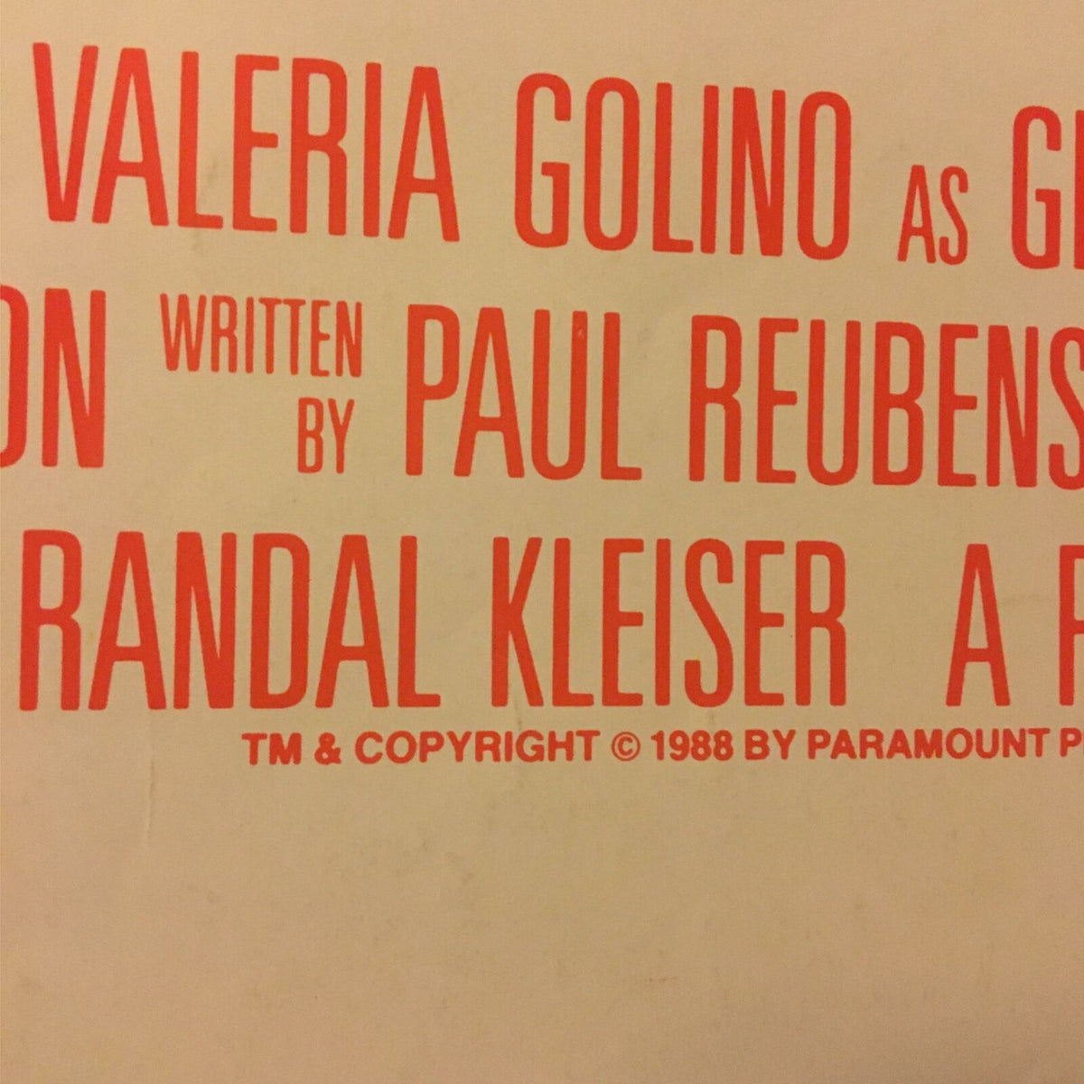 Detail image of the 1988 Big Top Pee-Wee Herman movie poster featuring the production credits in bold red text, attributed to Paul Reubens and Randal Kleiser.
