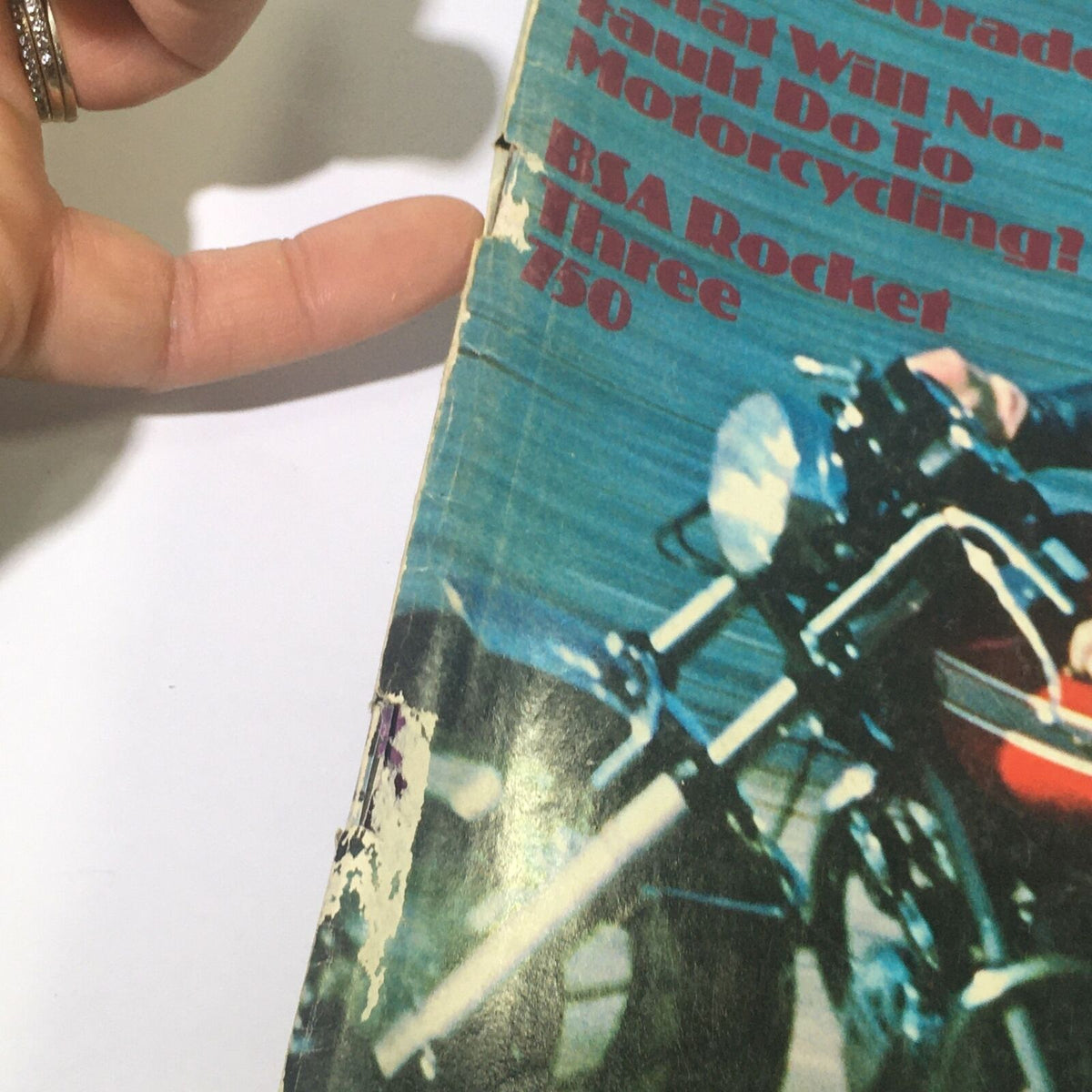 Close-up of the damaged edge of VTG Cycle Magazine July 1972, focusing on the title and the motorcycle image, highlighting vintage magazine wear.