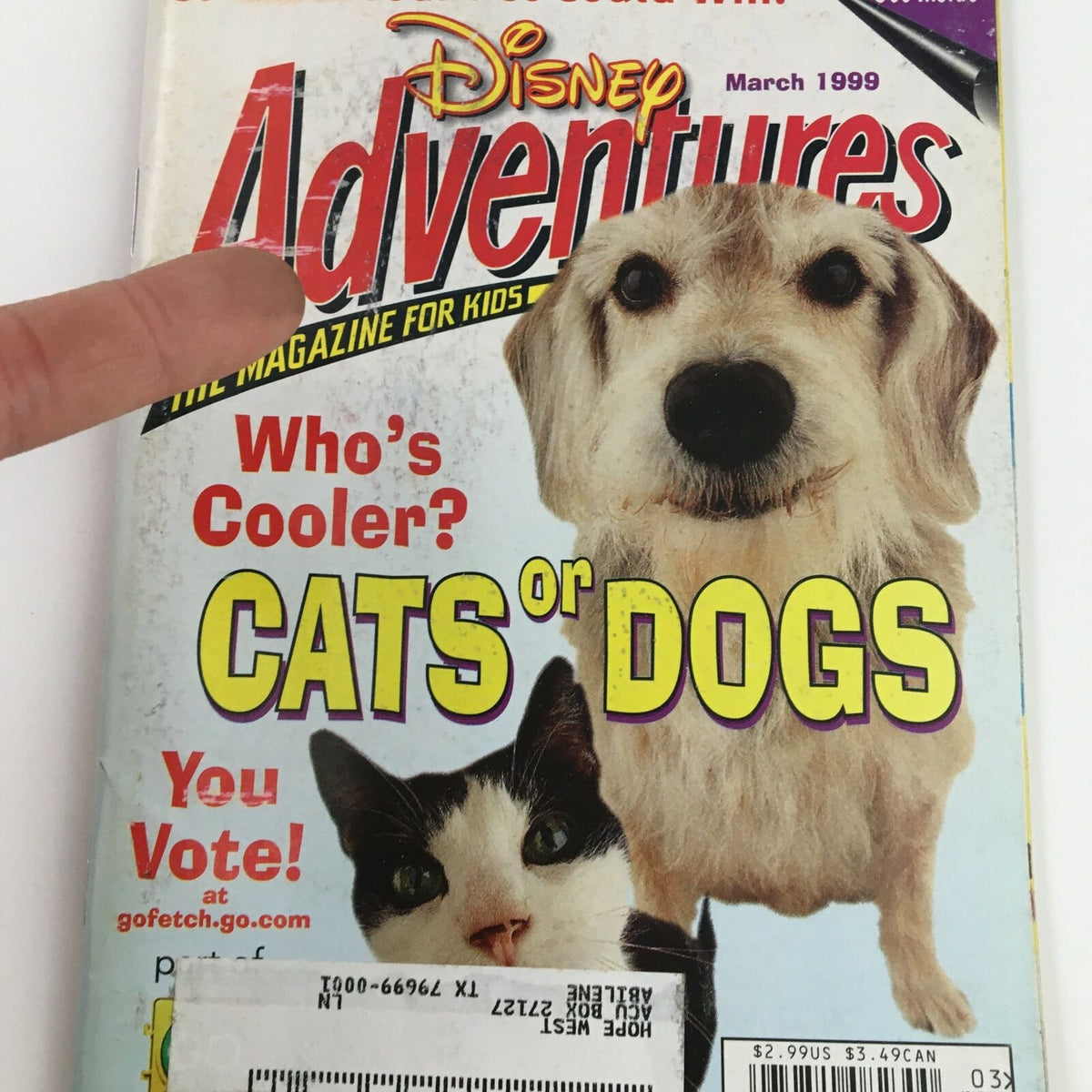 Cover of Disney Adventures Magazine from March 1999 featuring a voting contest between cats and dogs, showcasing vibrant illustrations of a dog and a cat, perfect for pet lovers and collectors.