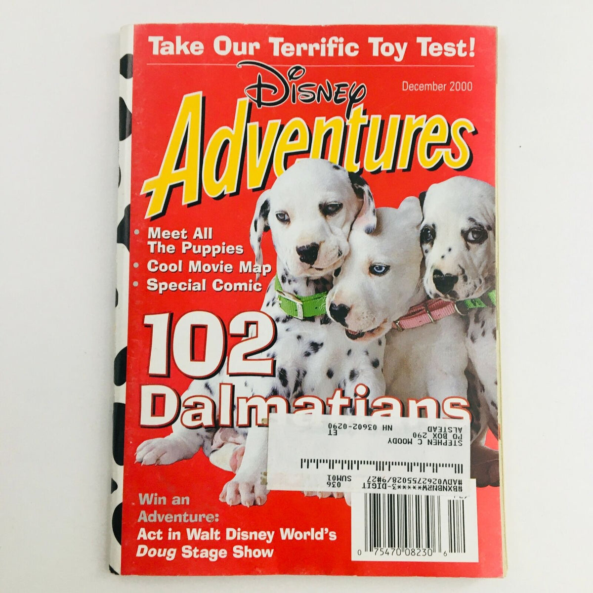 Cover of Disney Adventures Magazine, December 2000 issue featuring '102 Dalmatians Meet All The Puppies'. The cover showcases adorable puppy illustrations and a vibrant red background, ideal for Disney fans and collectors.