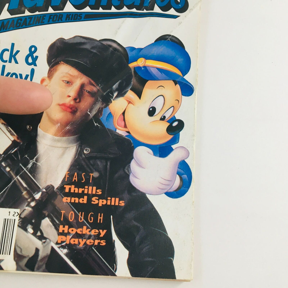 Close-up of Disney Adventures Magazine December 1993 cover featuring Macaulay Culkin and Mickey Mouse, highlighting the nostalgic appeal and character of this collectible magazine.
