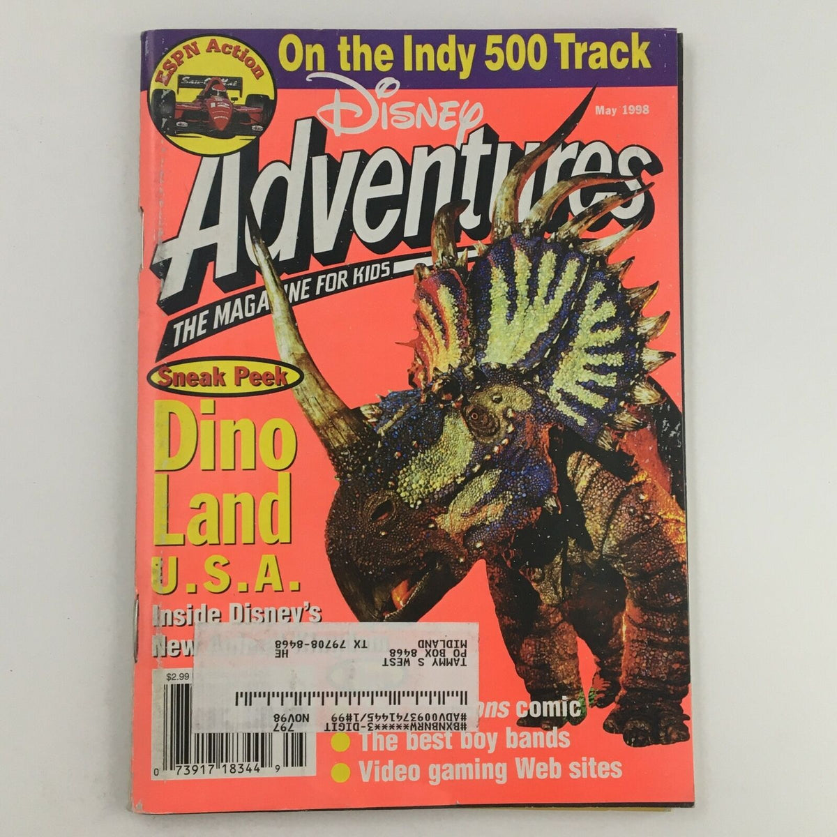 Cover of Disney Adventures Magazine May 1998 featuring Dino Land USA and ESPN on the Indy 500 Track, showcasing a colorful dinosaur illustration and bold magazine title.