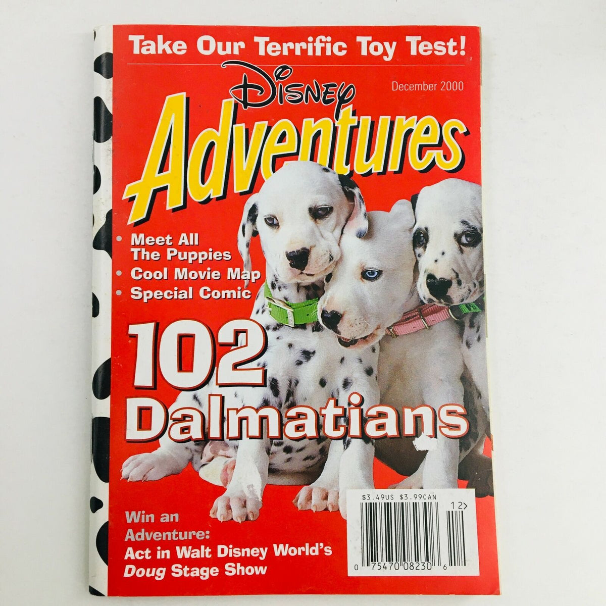 Disney Adventures Magazine December 2000 featuring 102 Dalmatians on the cover, showcasing adorable puppies, a vibrant red background, and promotional highlights such as 'Meet All The Puppies' and 'Special Comic'.