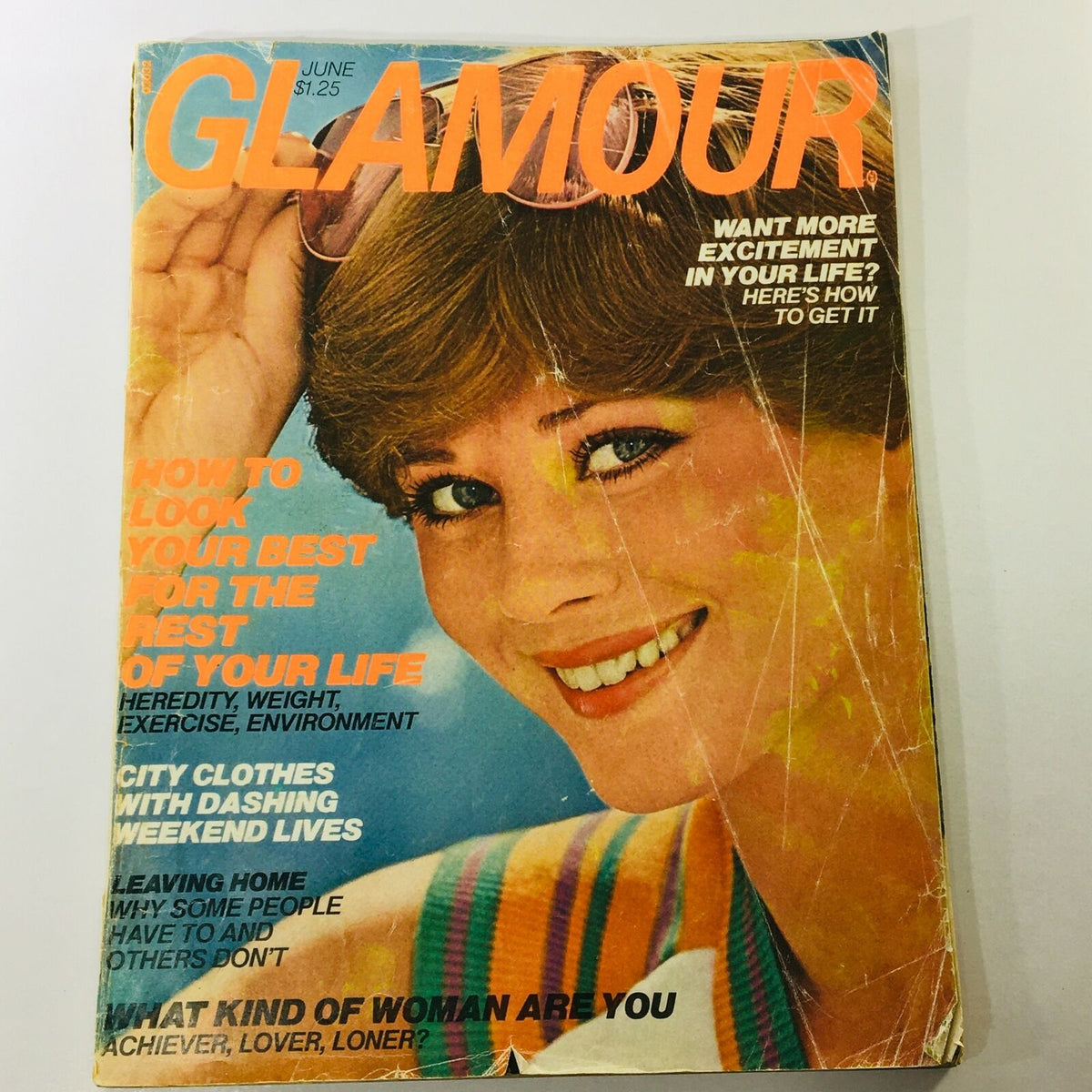 VTG Glamour Magazine June 1976 Shaun Casey Fashion Cover featuring a model with a playful smile and stylish sunglasses, highlighting 1970s fashion trends.