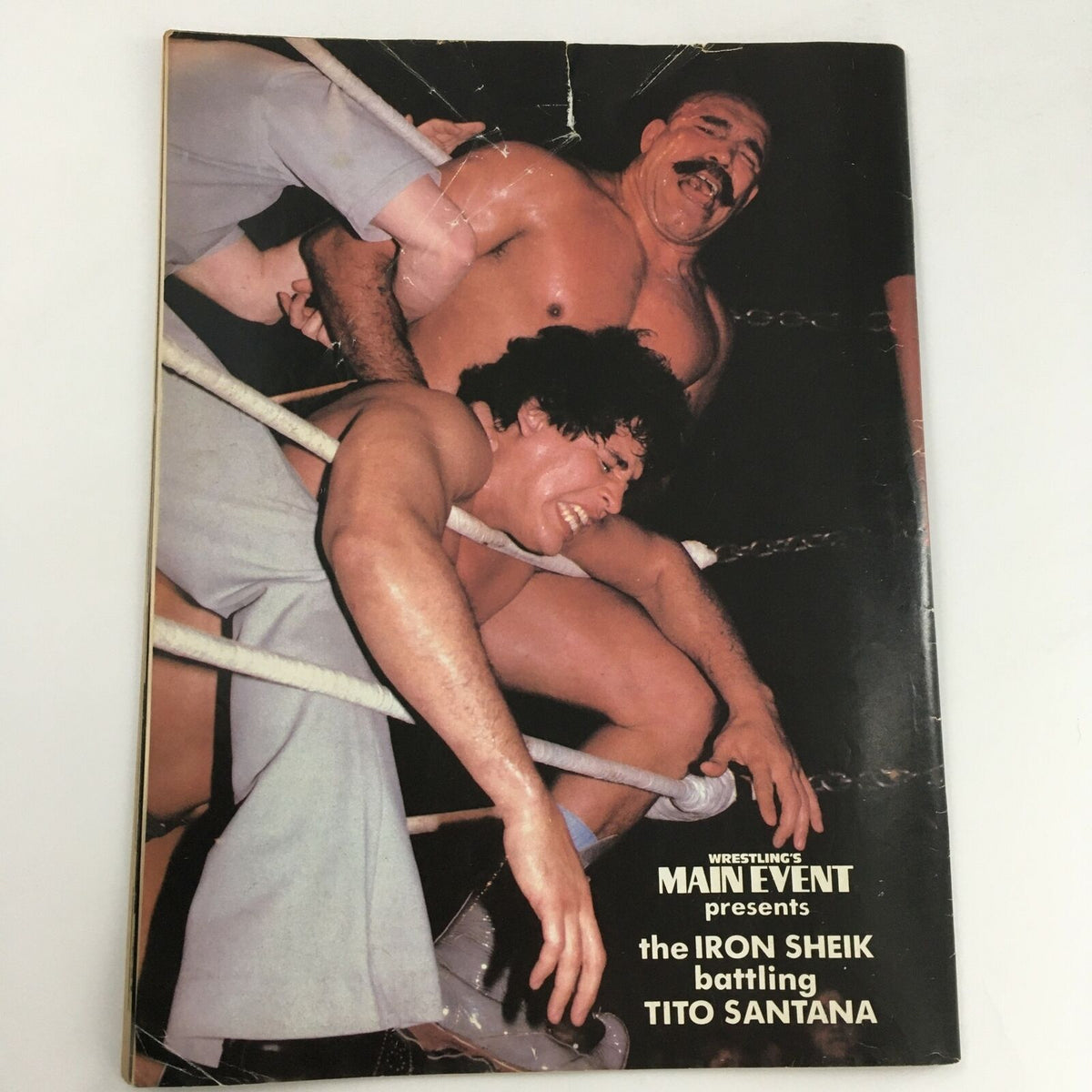 Wrestling's Main Event Magazine May 1983 page showing a wrestling match scene between the Iron Sheik and Tito Santana, illustrating the excitement of classic wrestling rivalries.