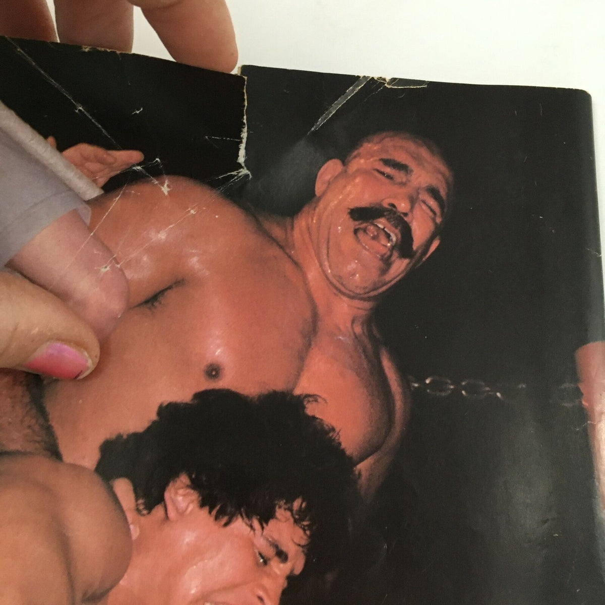 Wrestling's Main Event Magazine May 1983 page close-up of a wrestling match, capturing the intense expressions of the Iron Sheik and another competitor.