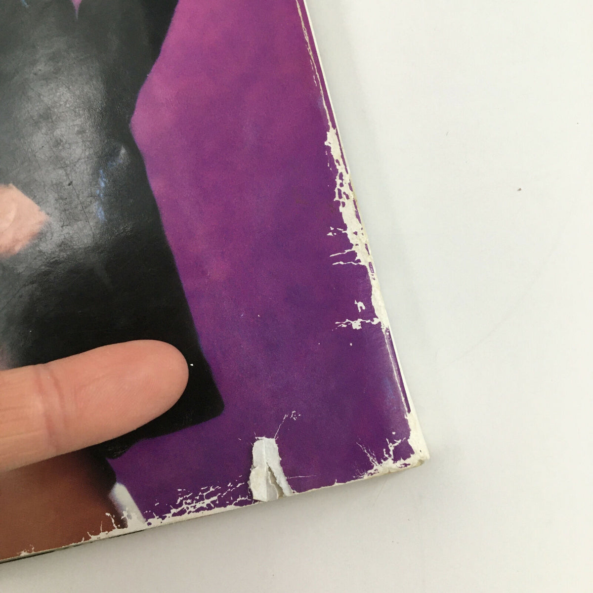 Close-up of the corner damage on the cover of WWF World of Wrestling Magazine May 1999 featuring Tammy Lynn. This image shows the magazine's wear, making it a vintage collectible.
