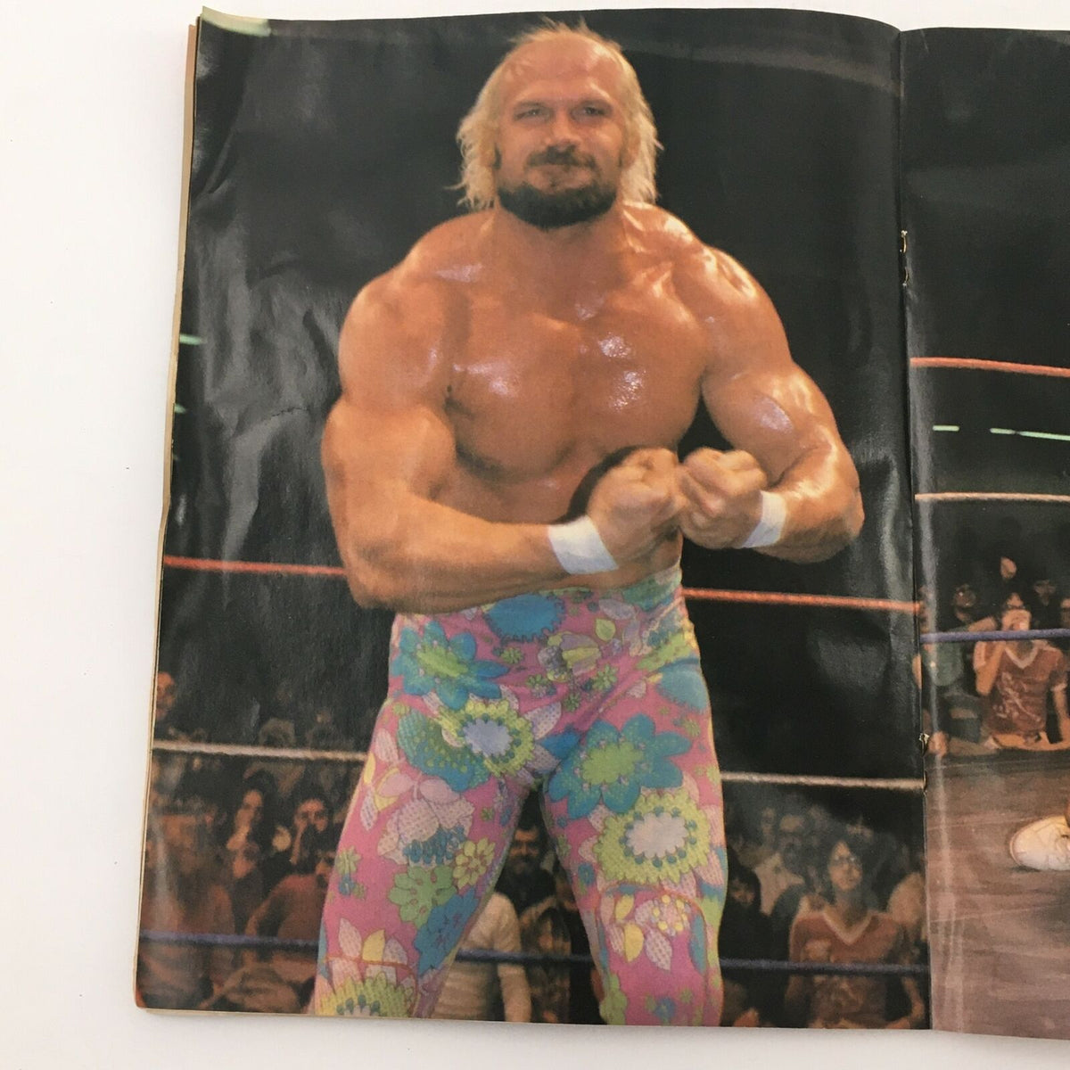 Photo from Wrestling's Main Event Magazine August 1982 depicting wrestler posing in colorful floral tights, representing the vibrant style of wrestling in the 1980s.