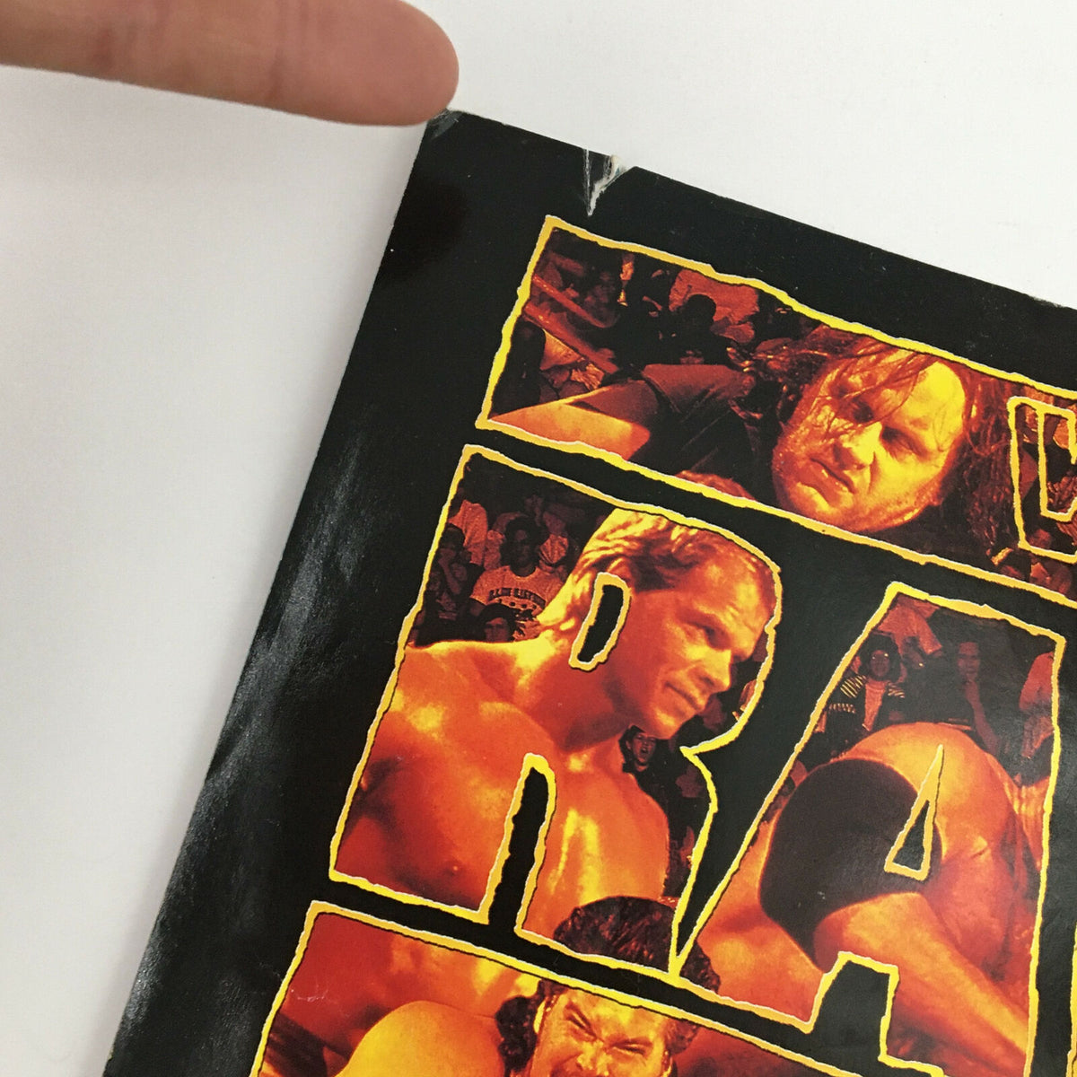 Close-up of the back cover of the World Wrestling Federation Magazine December 1994 featuring Doink The Clown, highlighting a minor tear and the 'RAW is WAR' design elements.