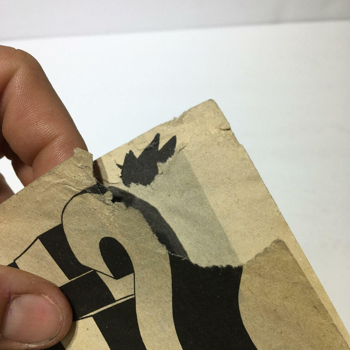 Detailed close-up of the corner of Wrestling 1976 Annual #17, showing signs of wear and damage with black and white wrestling imagery.