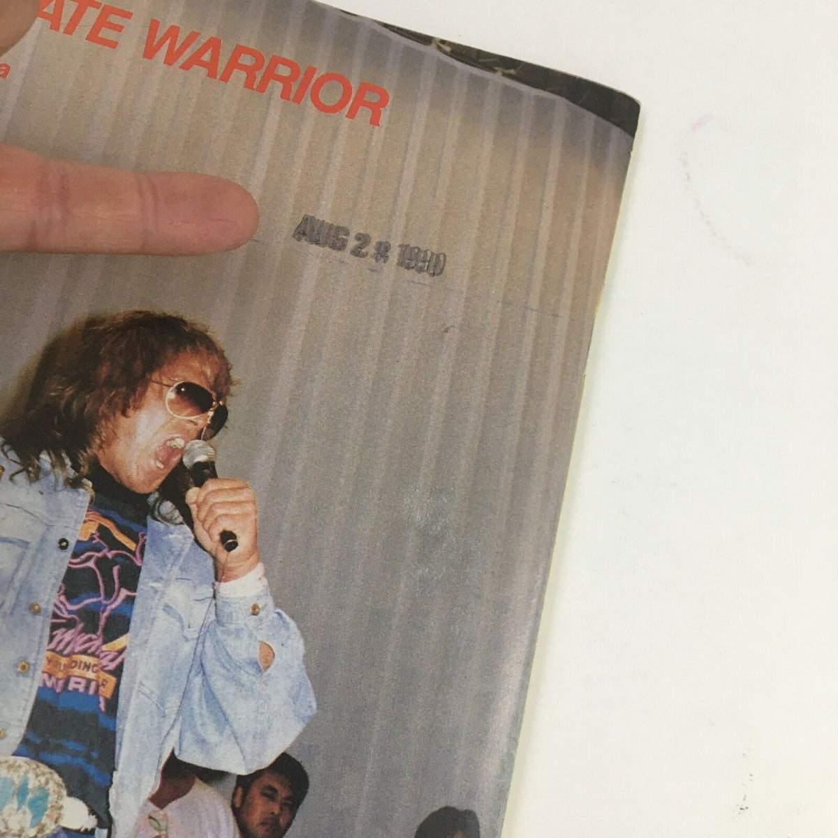 Close-up of the Ultimate Warrior image on the cover of Power Slam Wrestling Magazine November 1990 with a date stamp.