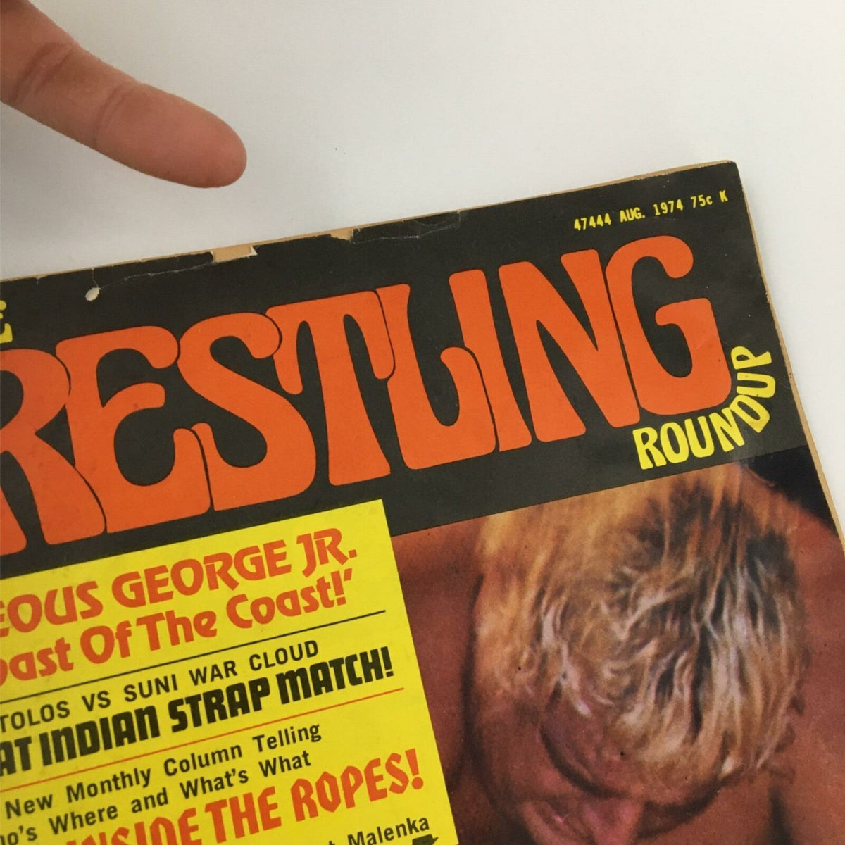 Close-up of the title on the Complete Wrestling Roundup Magazine August 1974 Gorgeous George Jr. showing wear and tear on the edge.