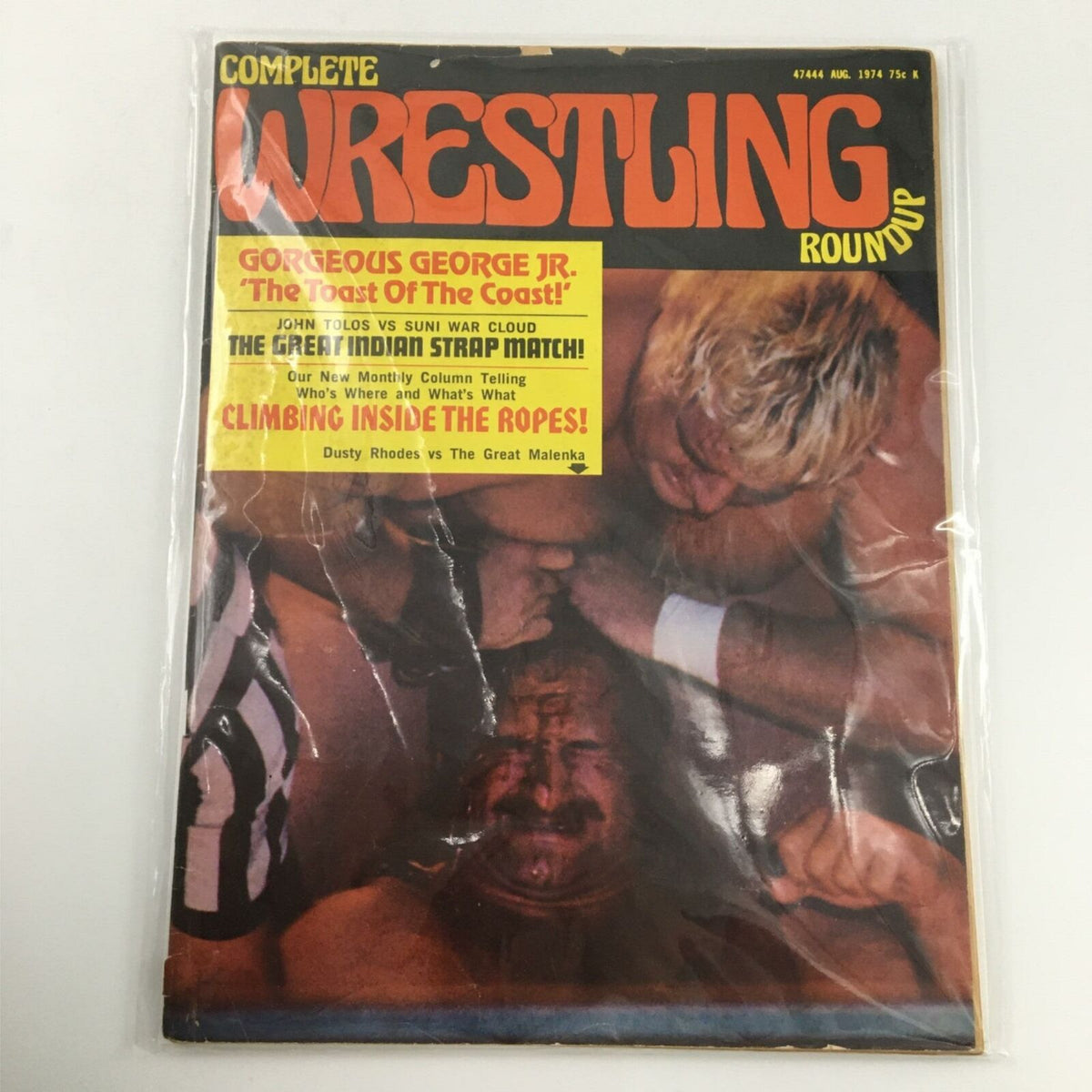 Complete Wrestling Roundup Magazine August 1974 Gorgeous George Jr. displayed in protective plastic, highlighting its nostalgic wrestling cover.