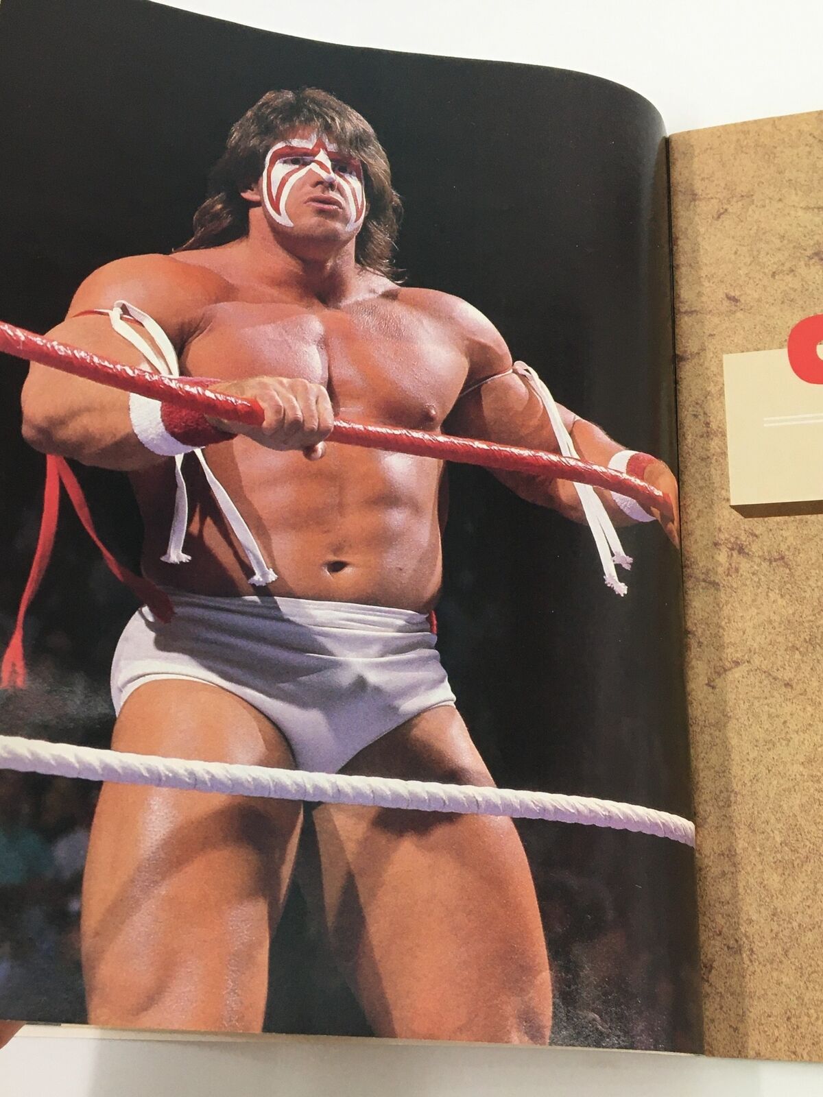 Interior image from VTG WWF Magazine March 1988 featuring The Ultimate Warrior, known for his dynamic wrestling style, posing in the ring. His iconic face paint and muscular physique exemplify the era's wrestling heroes.
