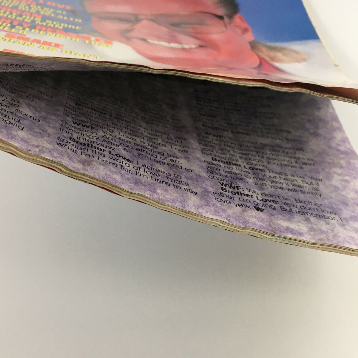 Close-up view of the pages inside WWF Magazine January 1989, showing worn edges and text. Features content related to wrestling legends such as Hulk Hogan, Hercules, and Jake The Snake.