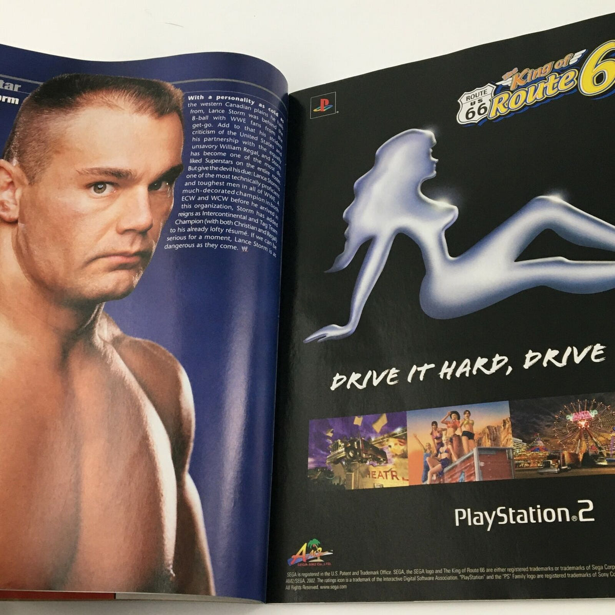 Inside spread of WWE Magazine April 2003 featuring an advertisement for PlayStation 2 with John Cena.