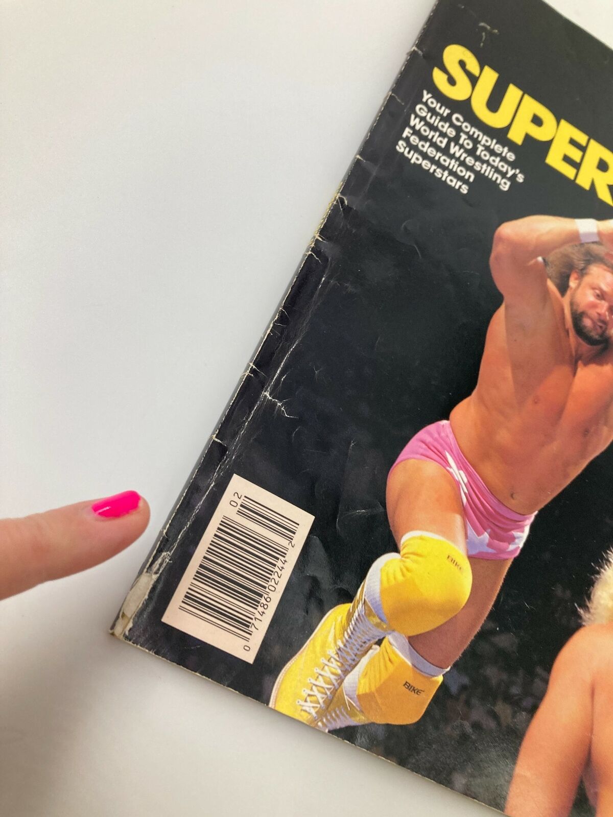 The World Wrestling Federation Presents Superstars II 1987 Hulk Hogan showing the back cover with a barcode and a pointing finger indicating wear.