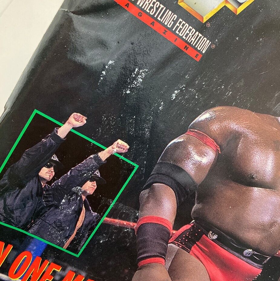 Close-up detail of the WWF World Wrestling Federation Magazine March 1997 cover featuring Ahmed Johnson alongside other wrestlers in an action pose.