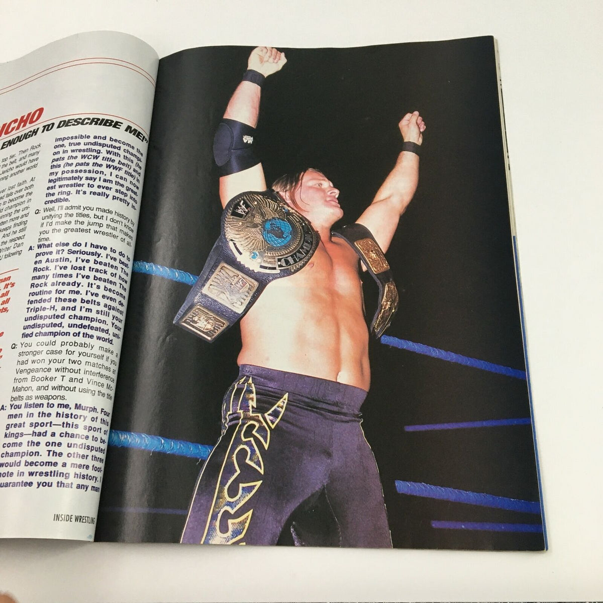 Inside Wrestling Magazine June 2002 Triple H Comeback Issue interior image showcasing a victorious wrestler holding championship belts.