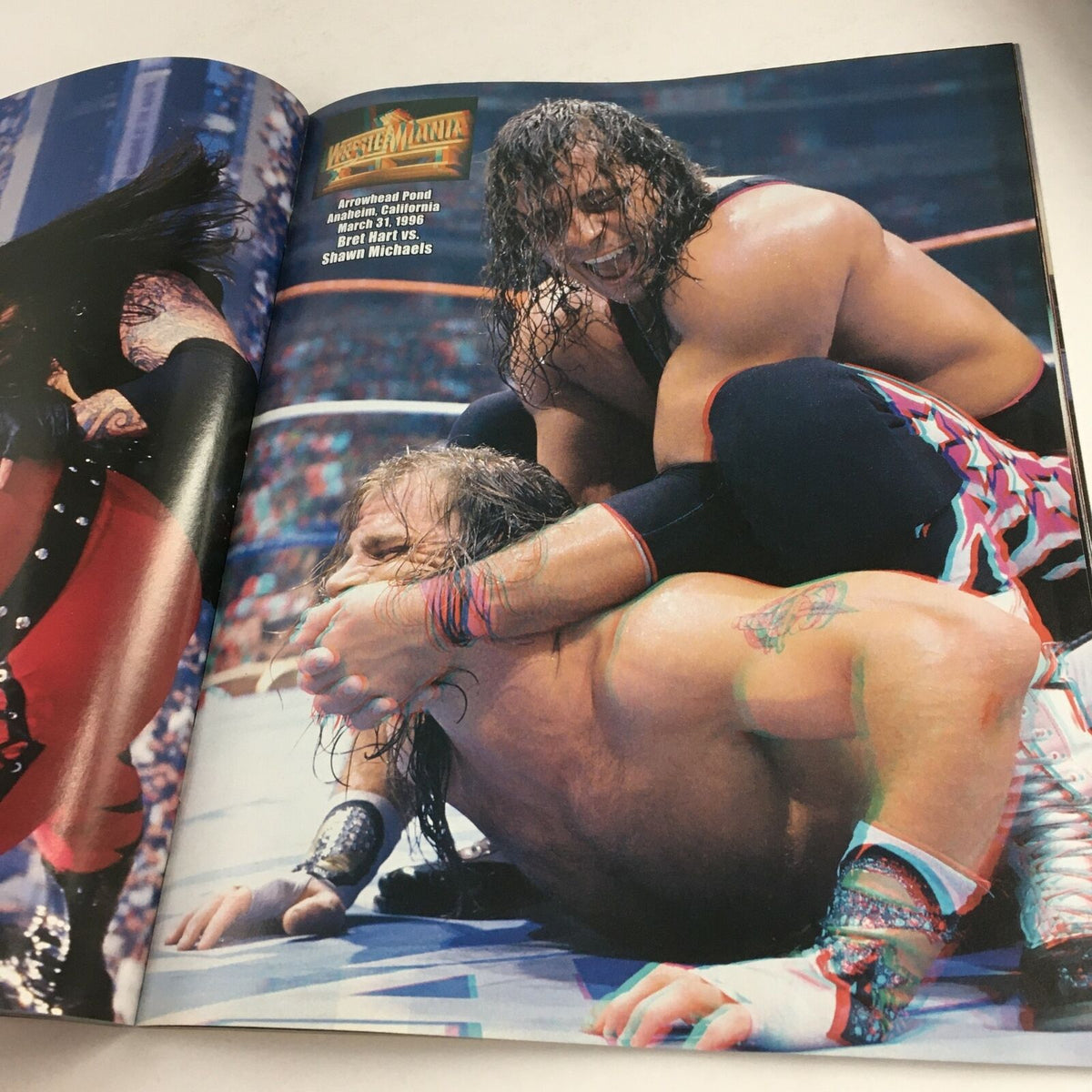 WWE Wrestle Mania April 2004 image of a wrestling match featuring popular superstars grappling in the ring.