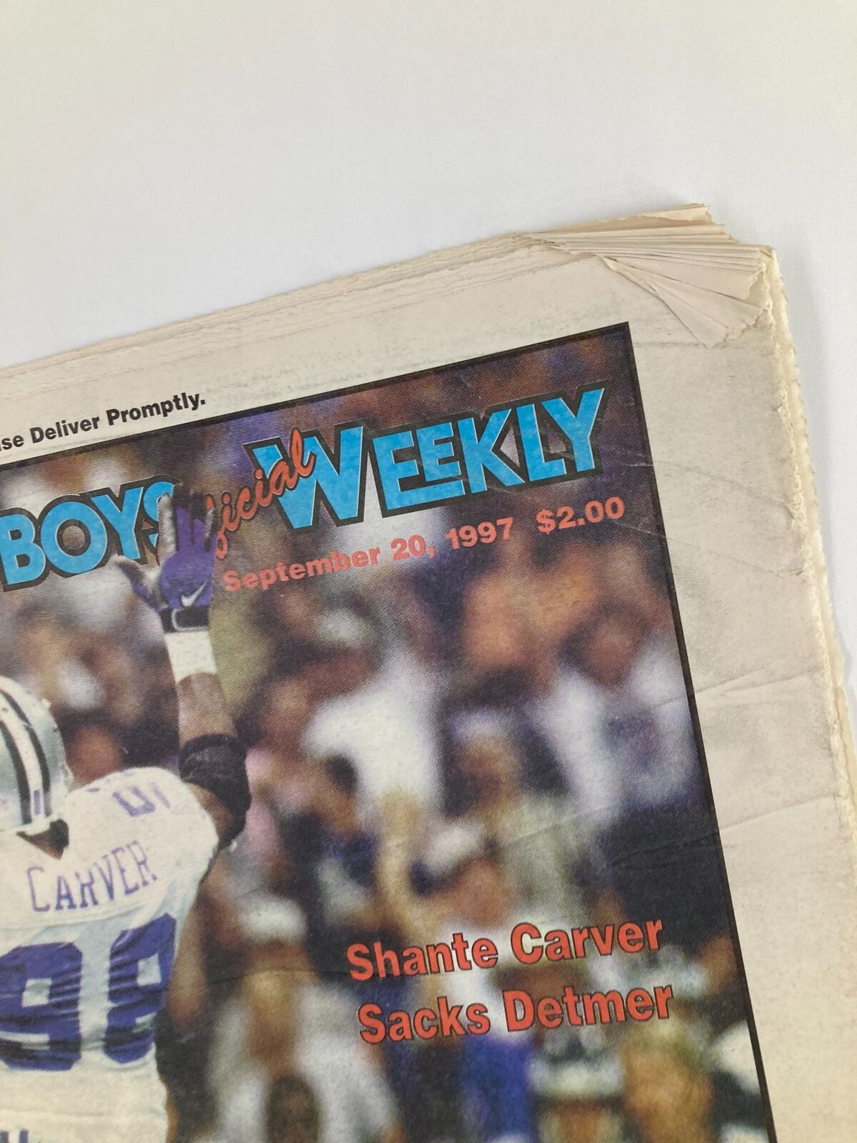 Close-up of the Dallas Cowboys Weekly Newspaper dated September 20 1997, Vol 23 #15, highlighting Shante Carver's name and the title, with visible wear on the newspaper.