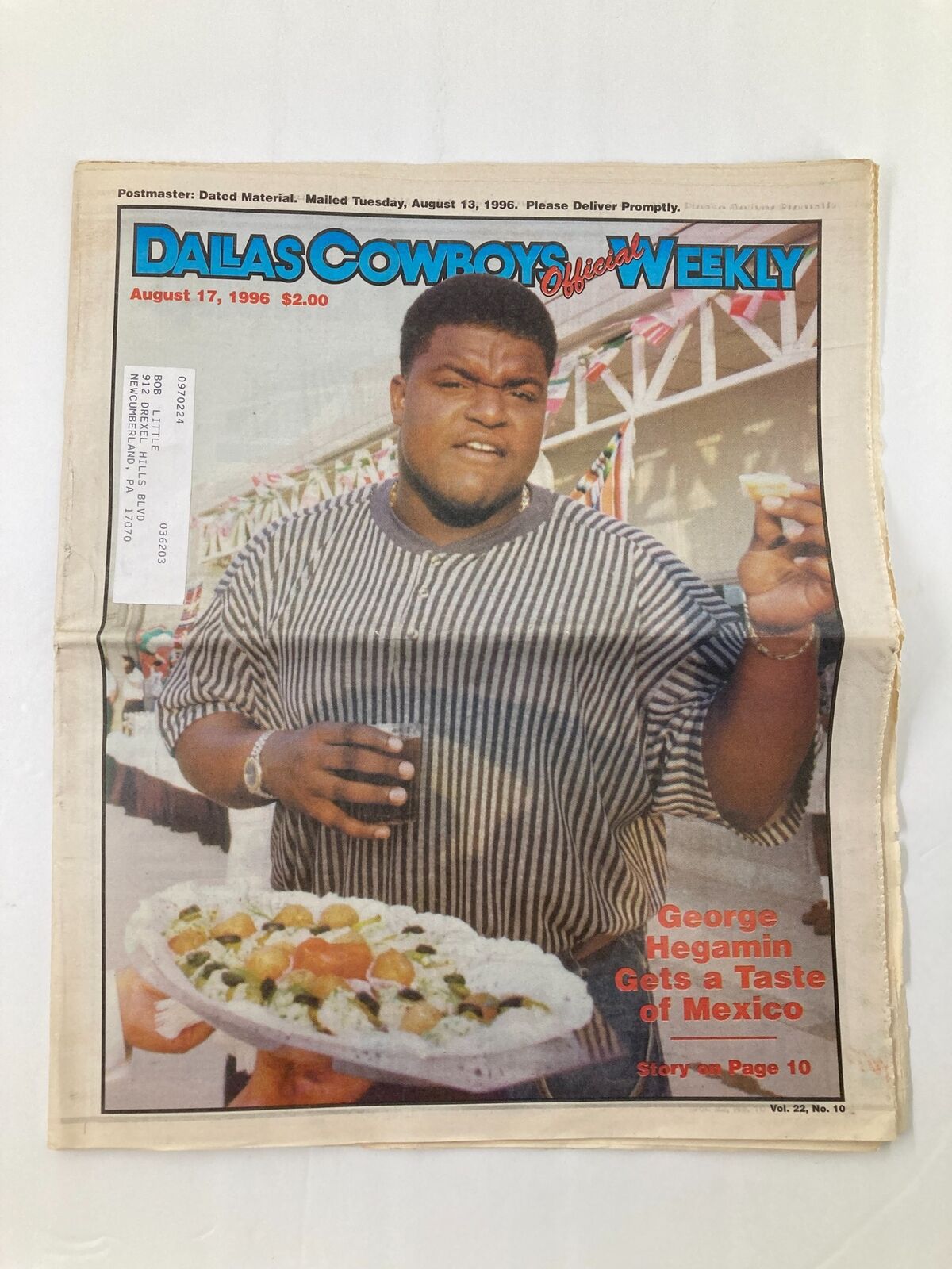 Dallas Cowboys Weekly Newspaper August 17 1996 Vol 22 #10 featuring George Hegamin, showcasing the player enjoying a plate of food, highlighting an article about his experiences in Mexico.