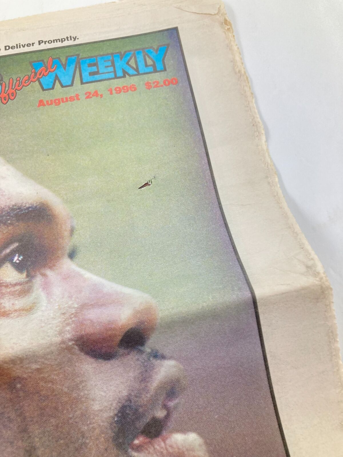 Close-up of the Dallas Cowboys Weekly Newspaper August 24 1996 Vol 22 #11 with a visible minor tear, focusing on Leon Lett's image. The newspaper is in good condition and comes folded.